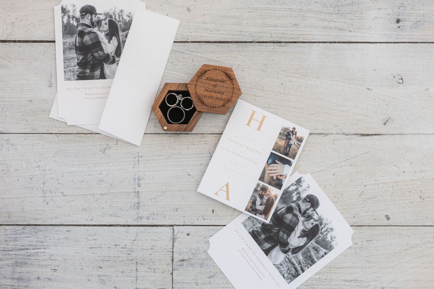 Black and white photo prints and a hexagonal wooden box displayed on a white wooden surface.