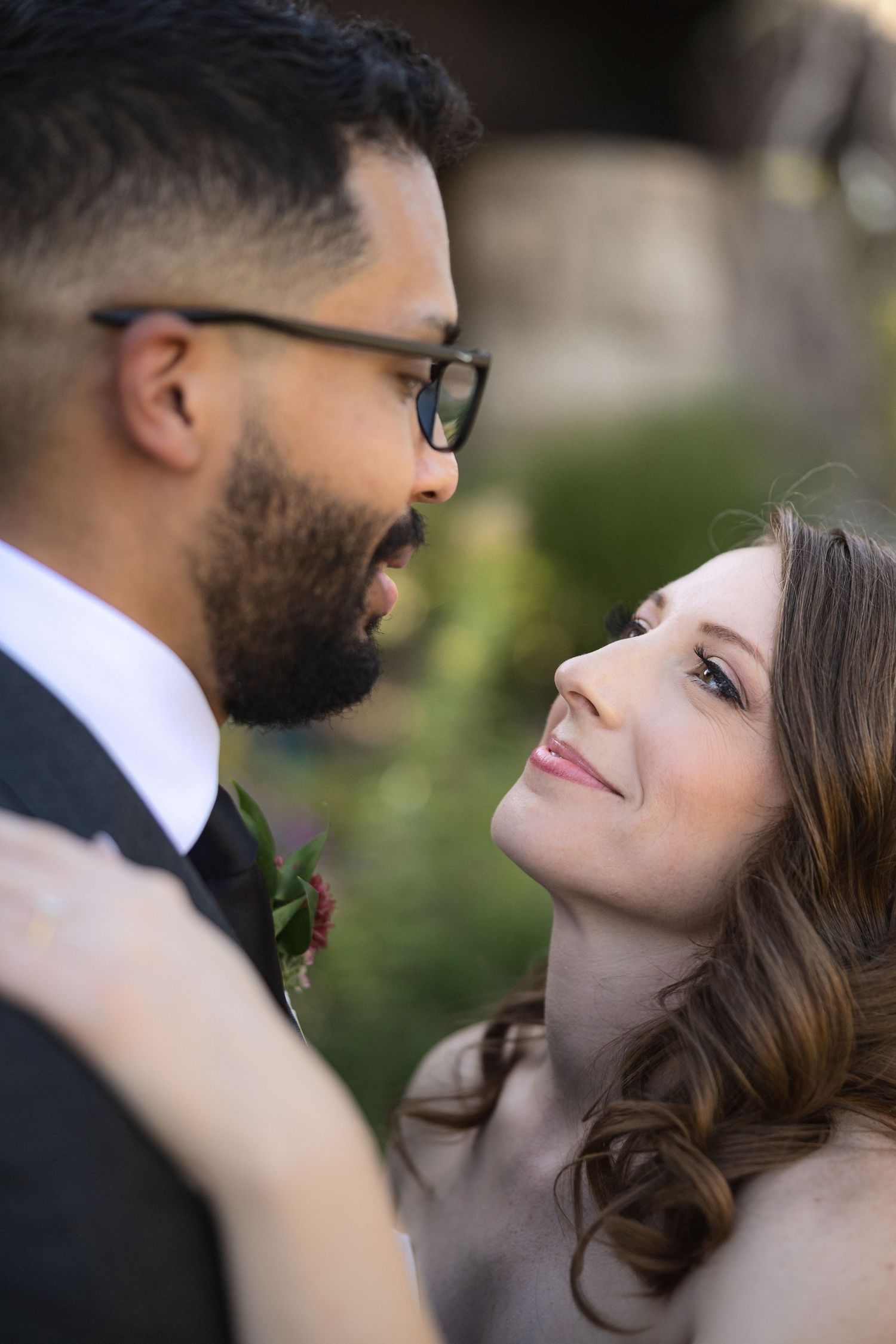 An intimate wedding portrait moment captured in natural outdoor lighting.