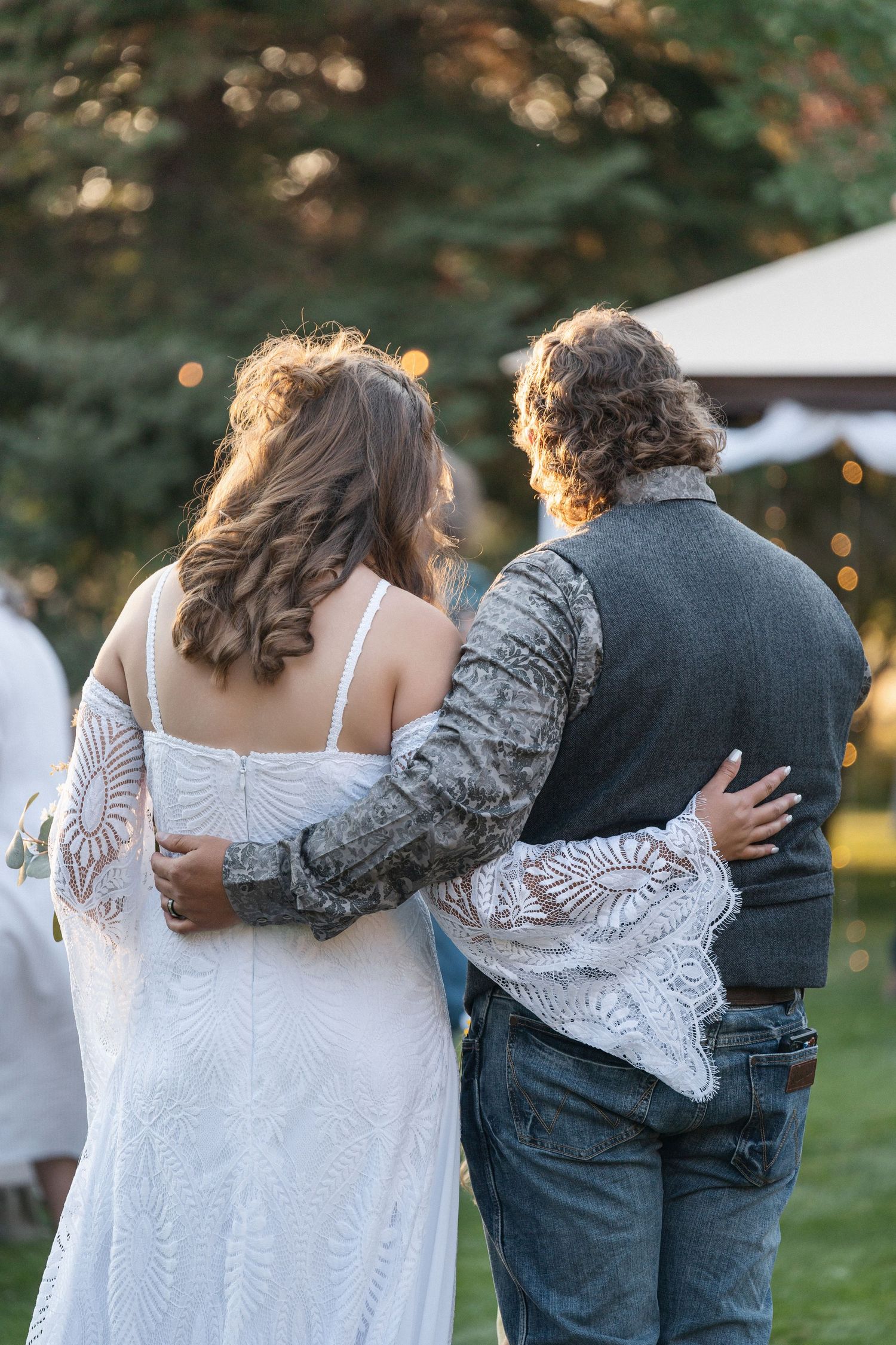 A sequence showing a couple embracing during a romantic outdoor celebration.
