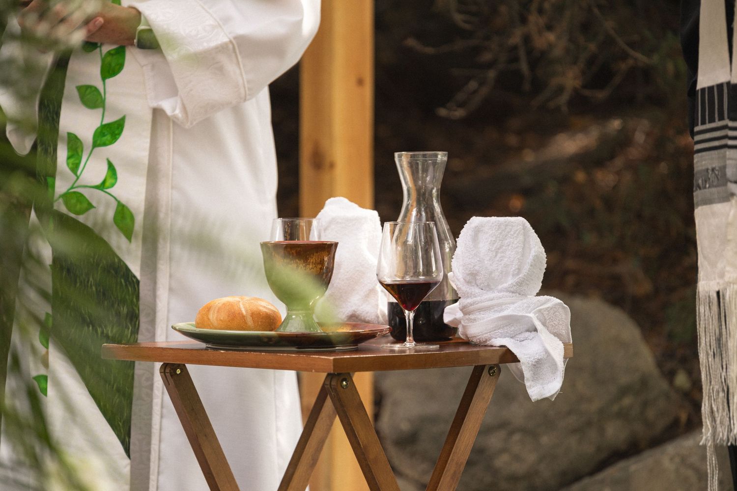 Wedding ceremony table with bread, candle holder and glassware arrangements.