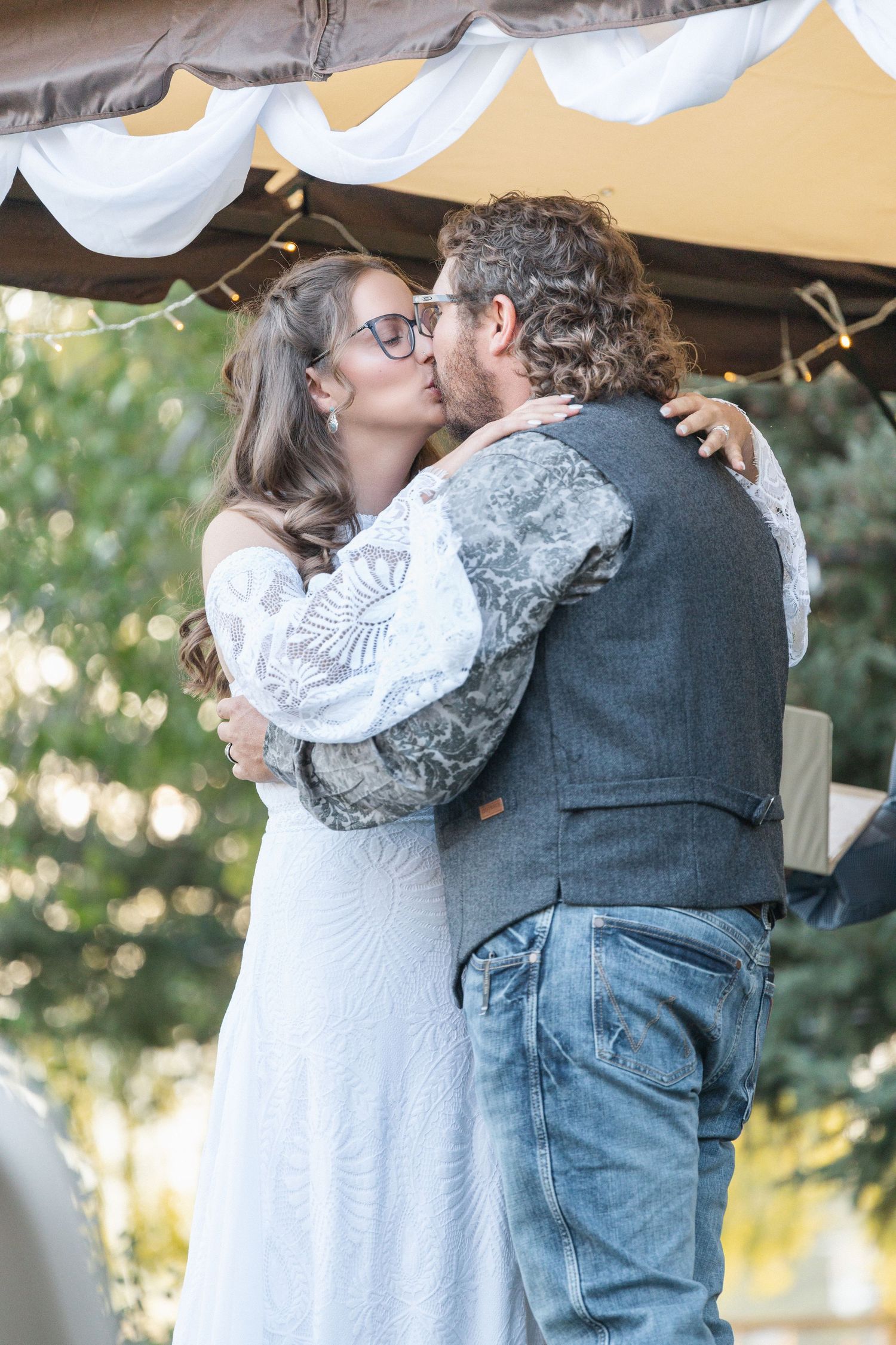 A romantic wedding couple embraces in a series of intimate moments captured in four similar photographs.