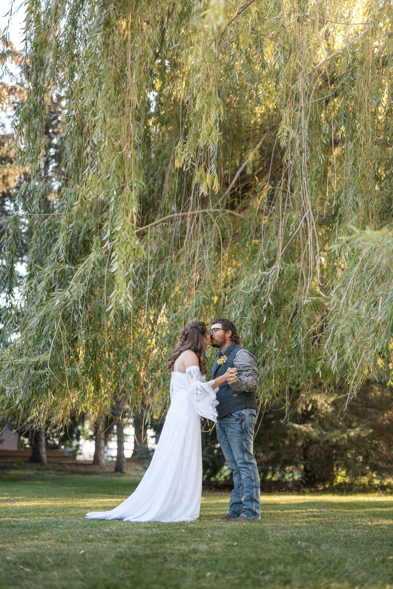A romantic dance sequence under a weeping willow tree on a sunny afternoon.