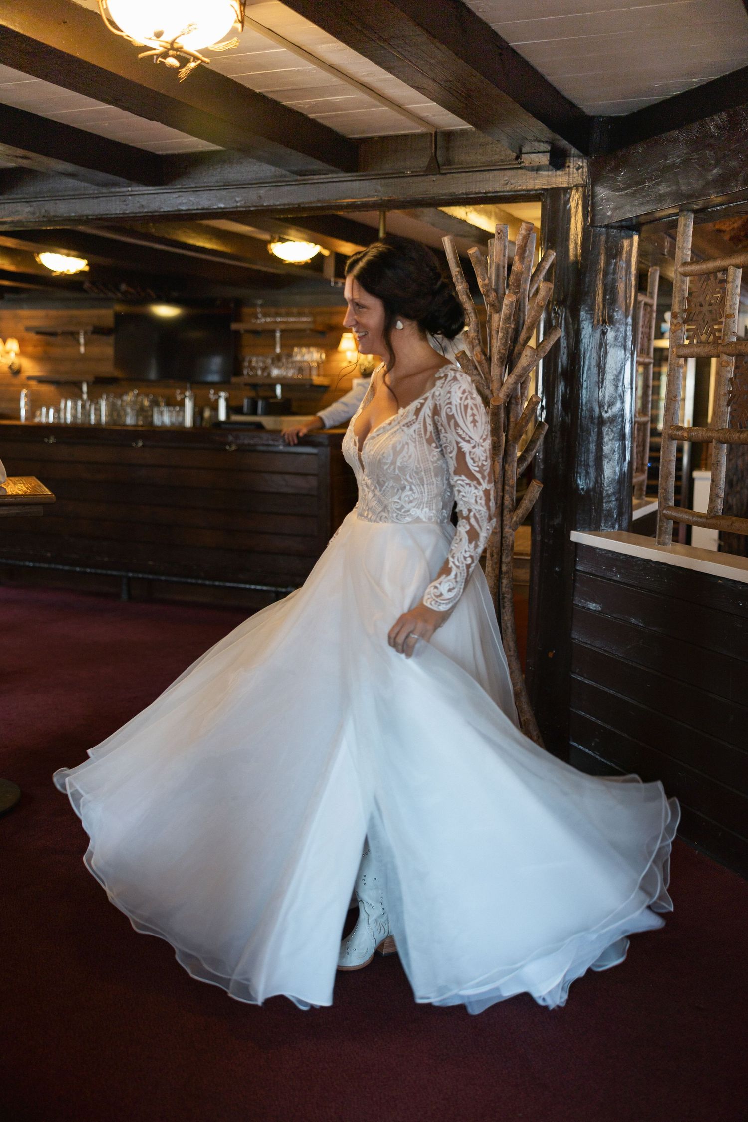Bride spinning in a voluminous white wedding gown showing off the full skirt.