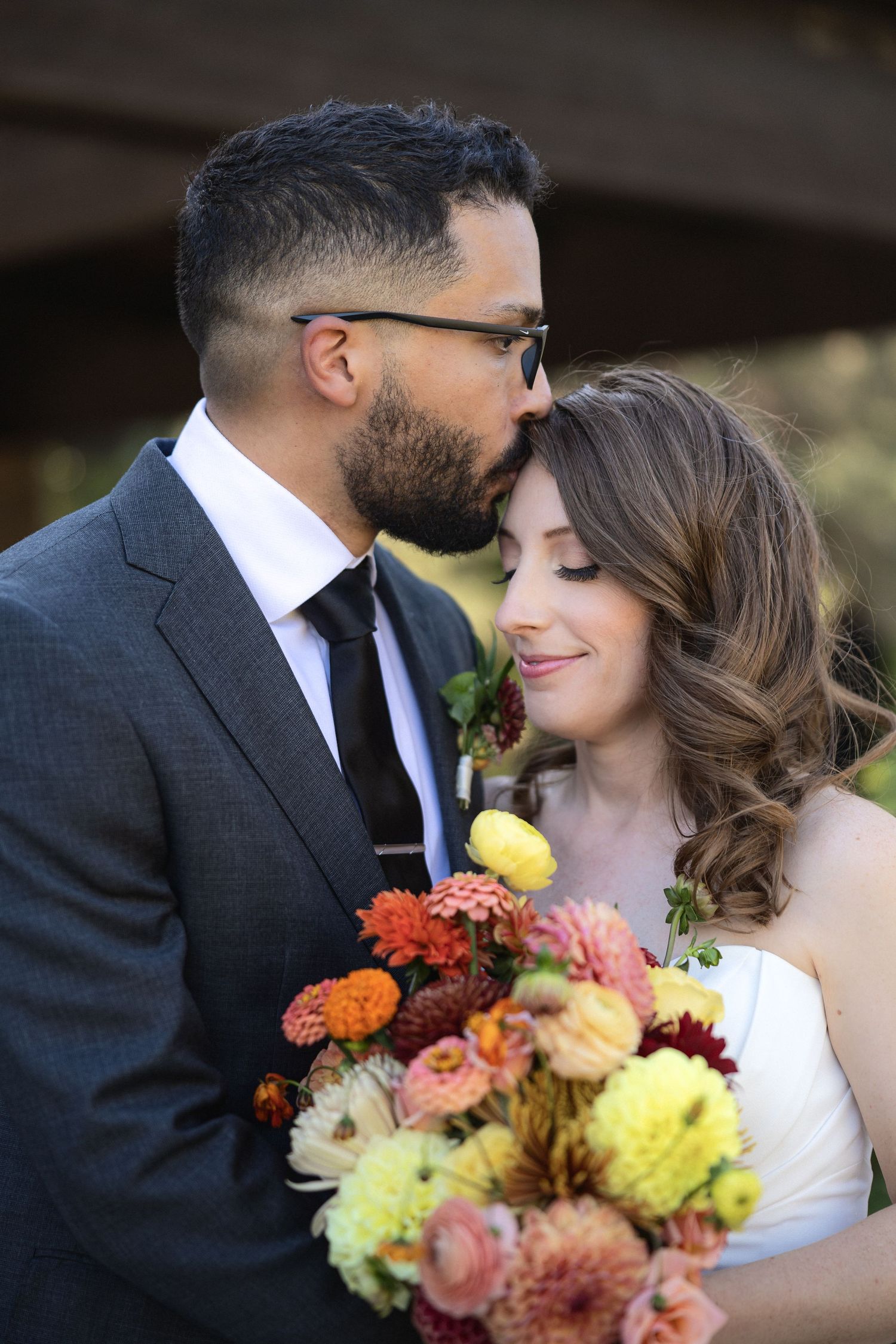 Romantic wedding portraits with colorful fall bouquet.