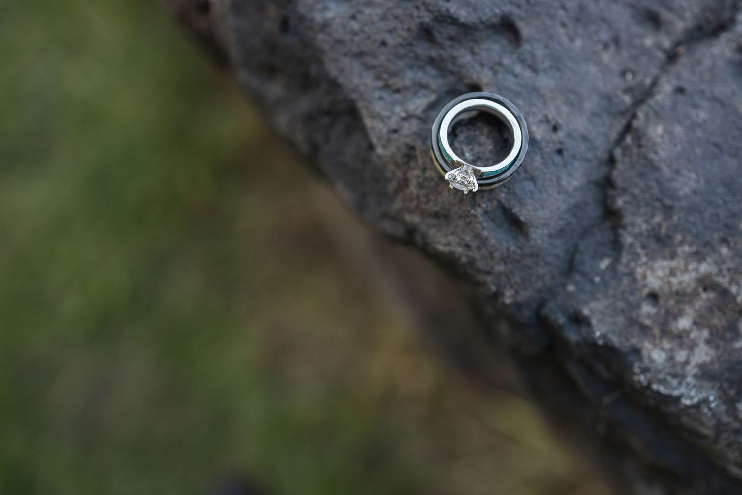 Close-up view of rough textured dark gray stone or rock surface with natural patterns and crevices.