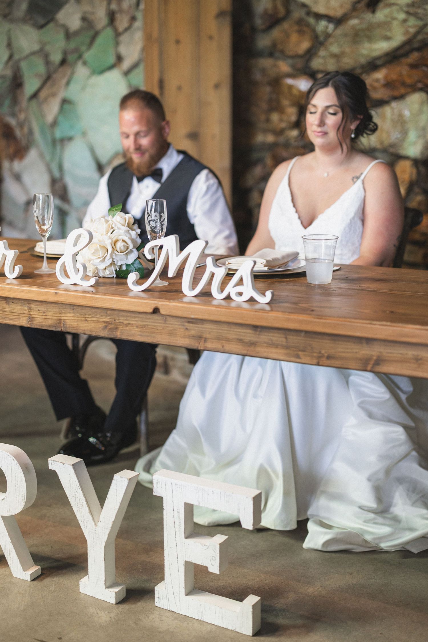 Wedding reception table with Mr & Mrs sign and decorative letters spelling Frye.