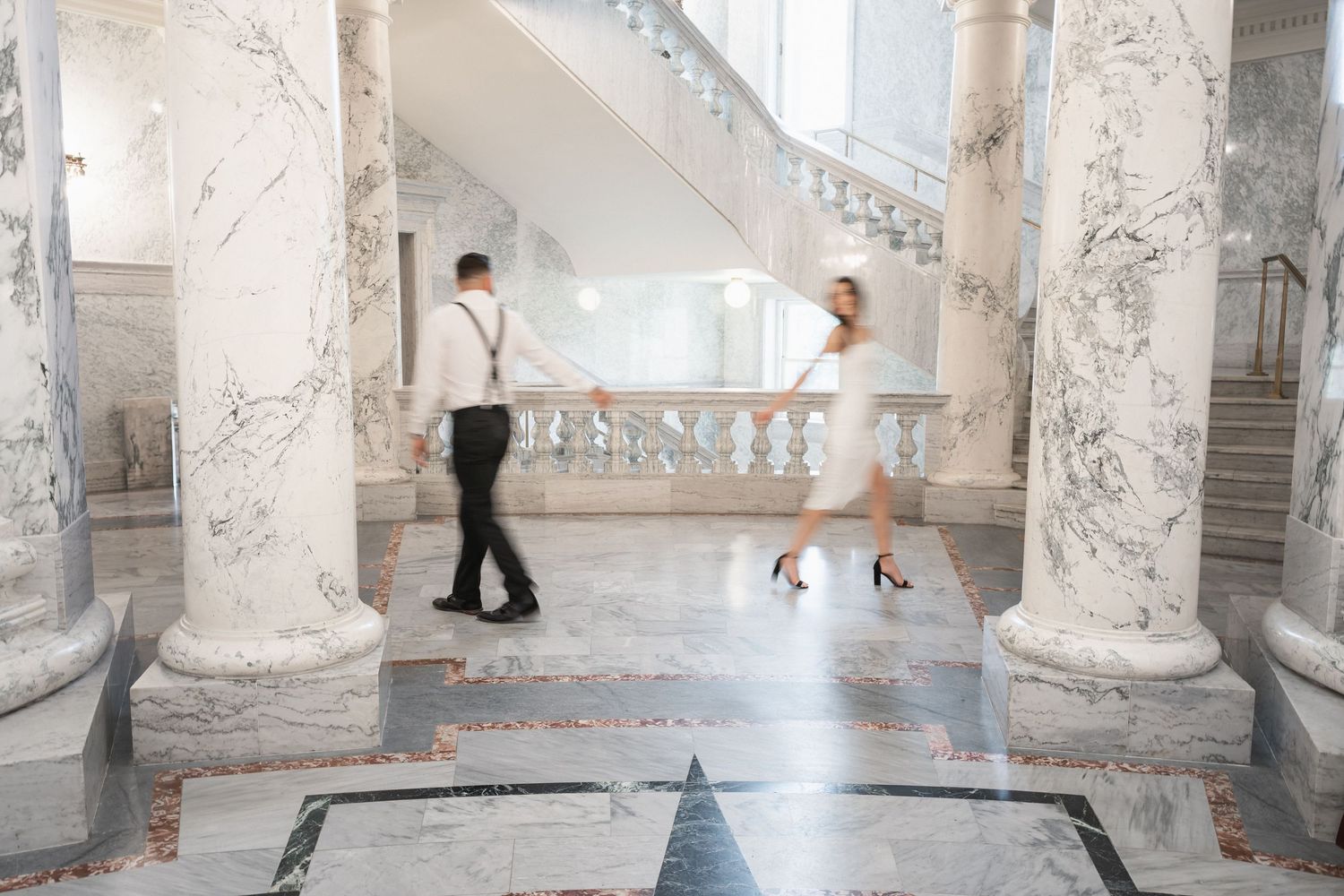 Classic interior hallway with white marble columns and elegant architectural details.