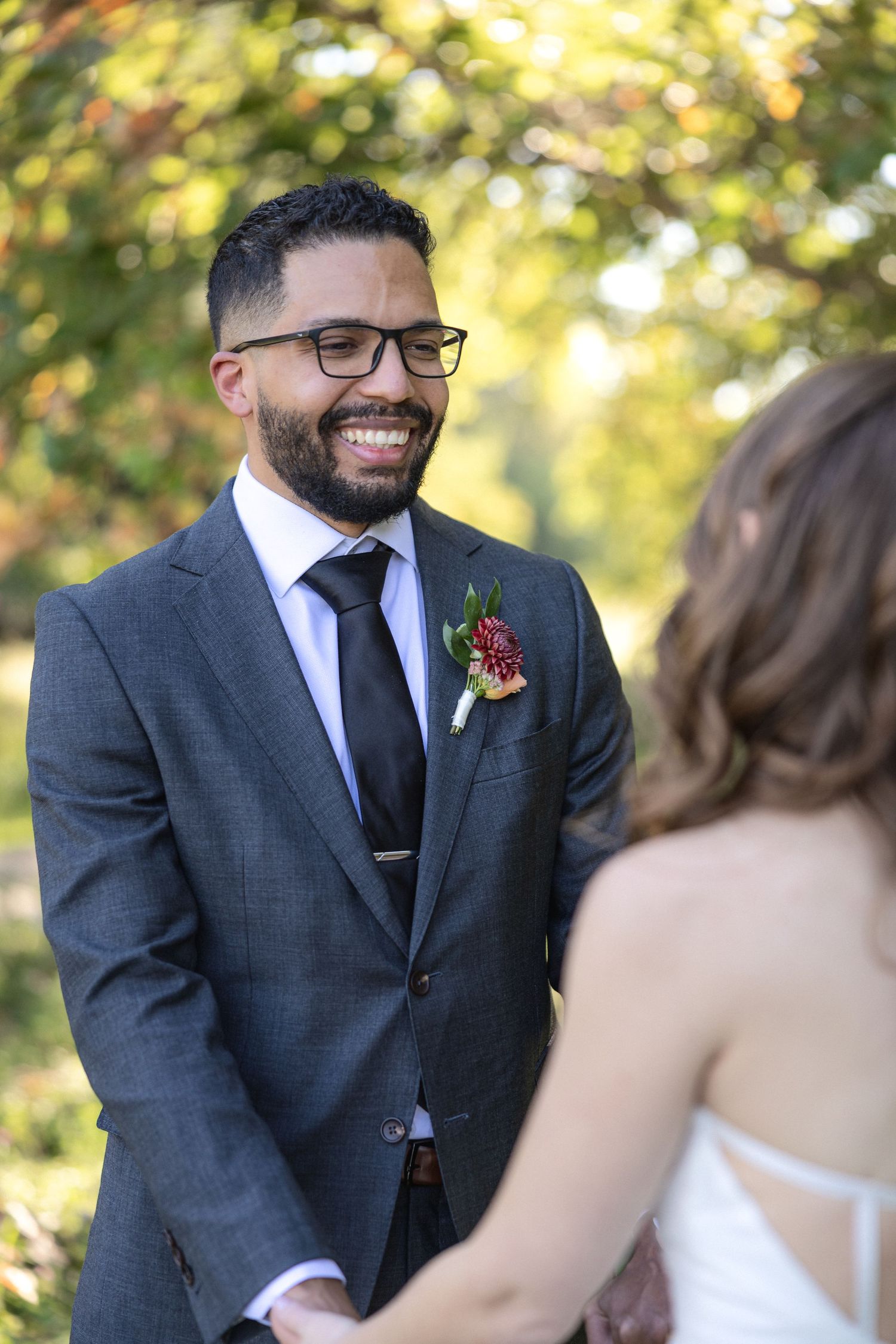 Intimate moment between couple during outdoor autumn wedding ceremony.