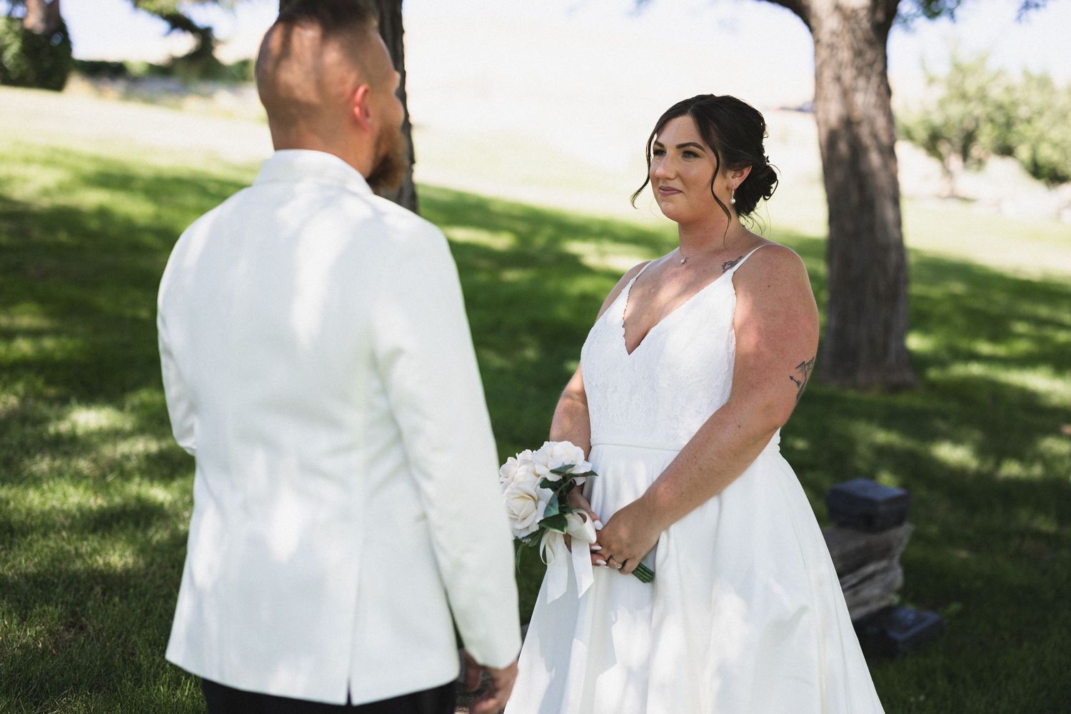 Couple shares a tender moment during their outdoor wedding ceremony.