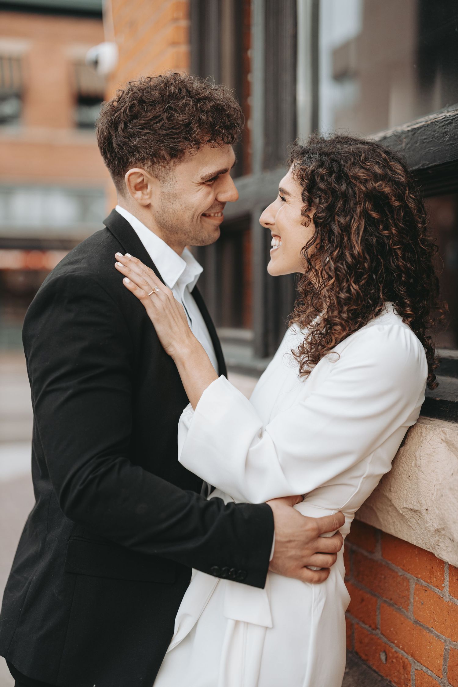 A joyful moment shared between a couple in contrasting black and white formal attire.