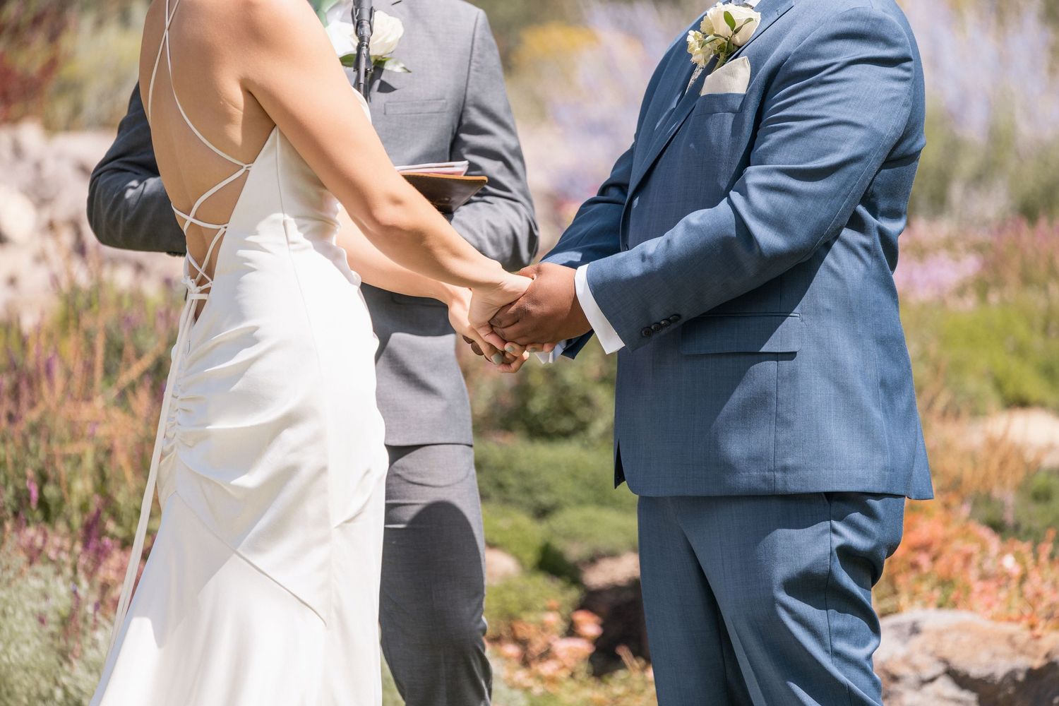 Intimate moments during an outdoor wedding ceremony with blue and white attire.