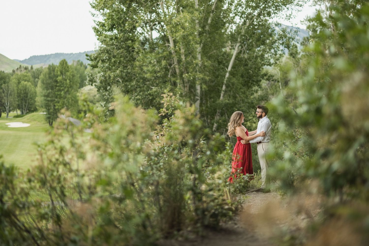 A montage of outdoor engagement photo session images showing couples posing in a lush green natural setting.