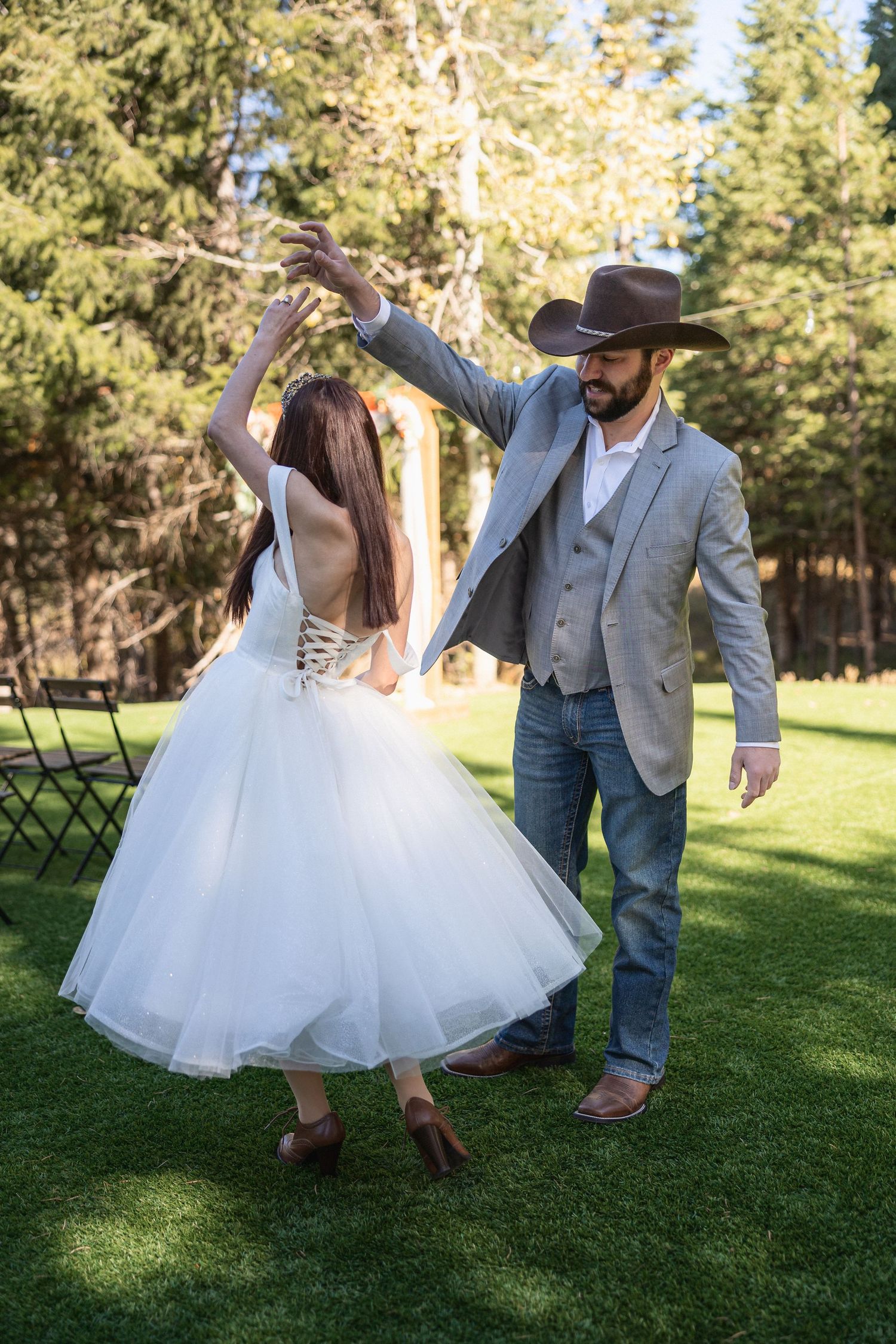 A playful dancing sequence shows a couple twirling in a grassy outdoor venue.