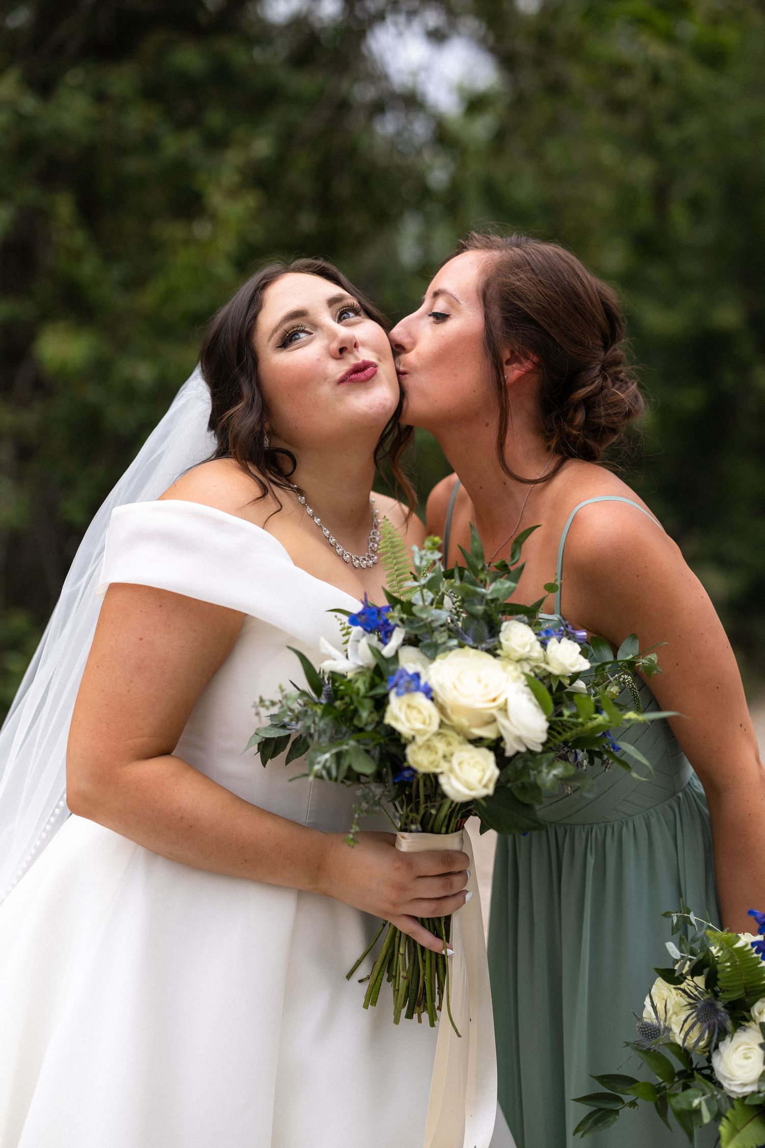 Close-up sequence of wedding party members sharing embraces while holding white and blue bouquets.