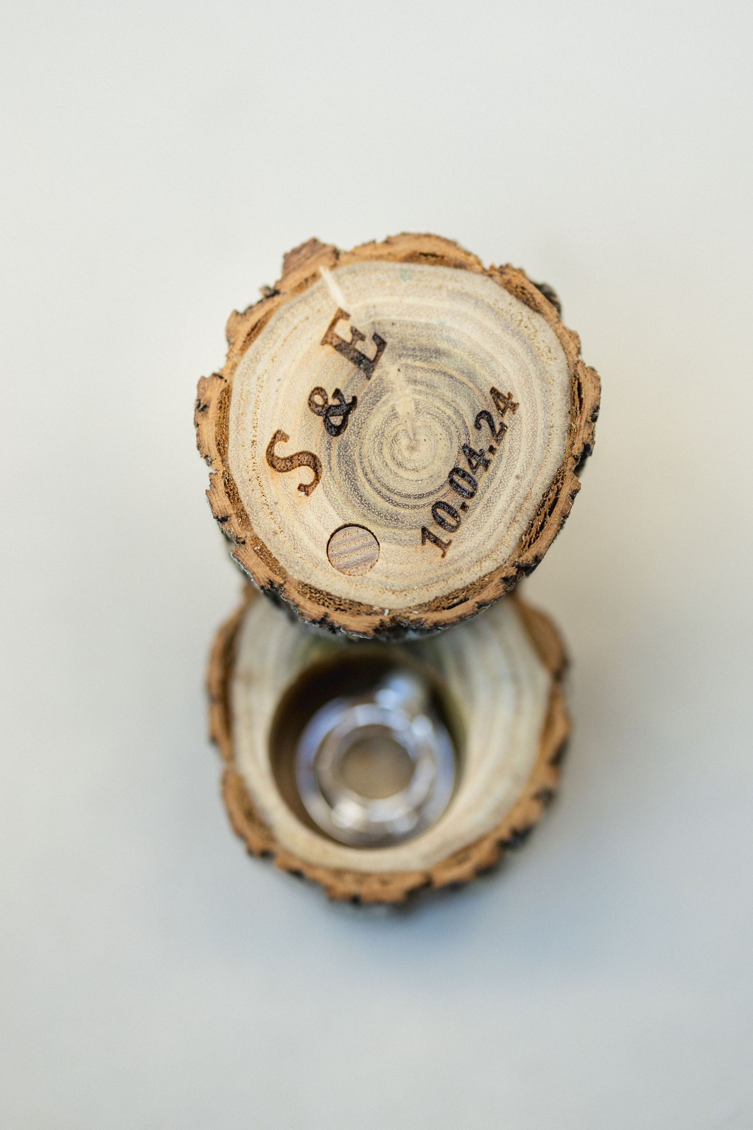 Wooden ring box with carved initials and wedding date.
