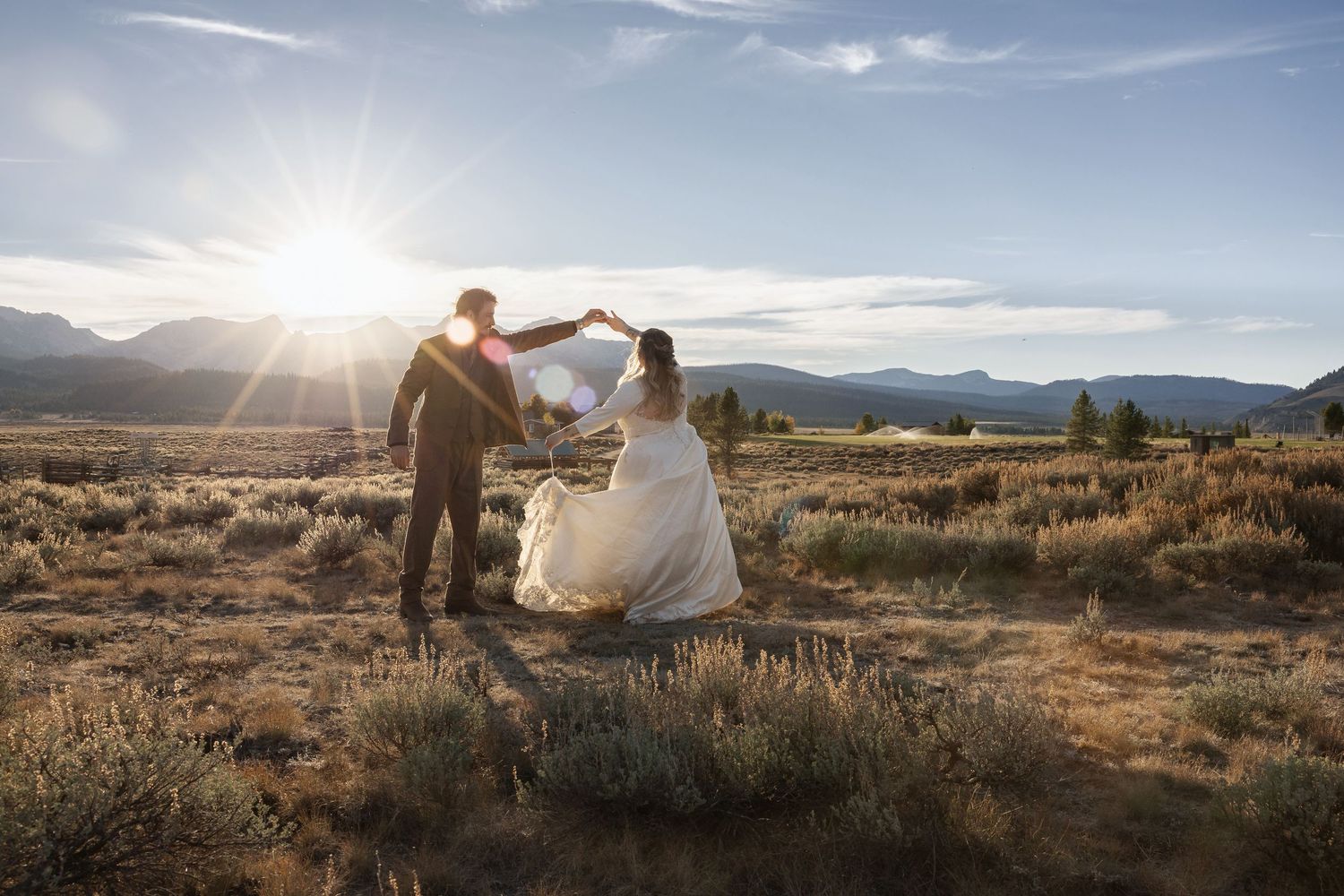Scenic desert wedding venue with mountain backdrop and dramatic sunset lighting.