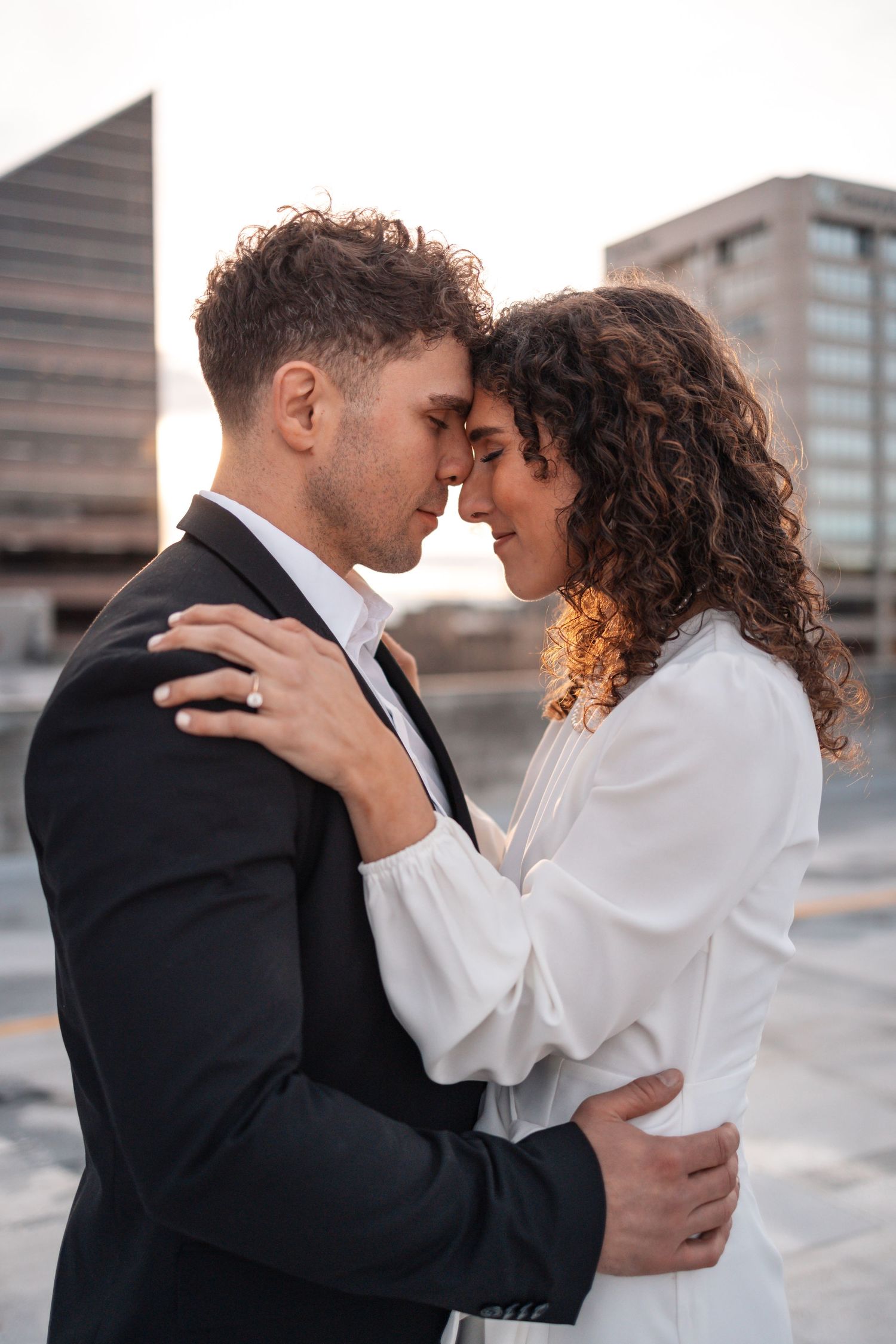 Romantic embrace captured in series of close-up shots on city rooftop.