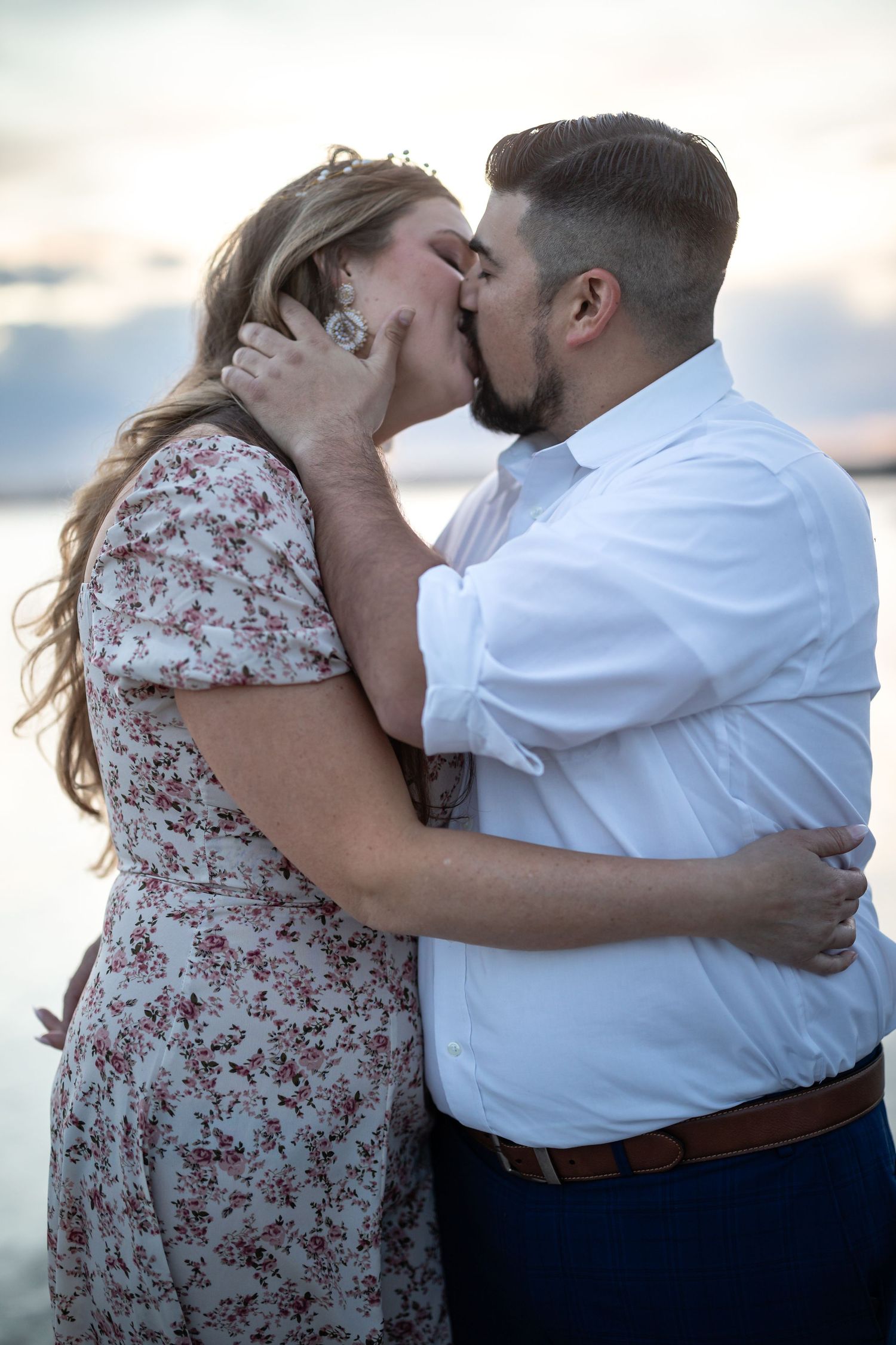 Intimate embrace shared during waterfront photoshoot at dusk.