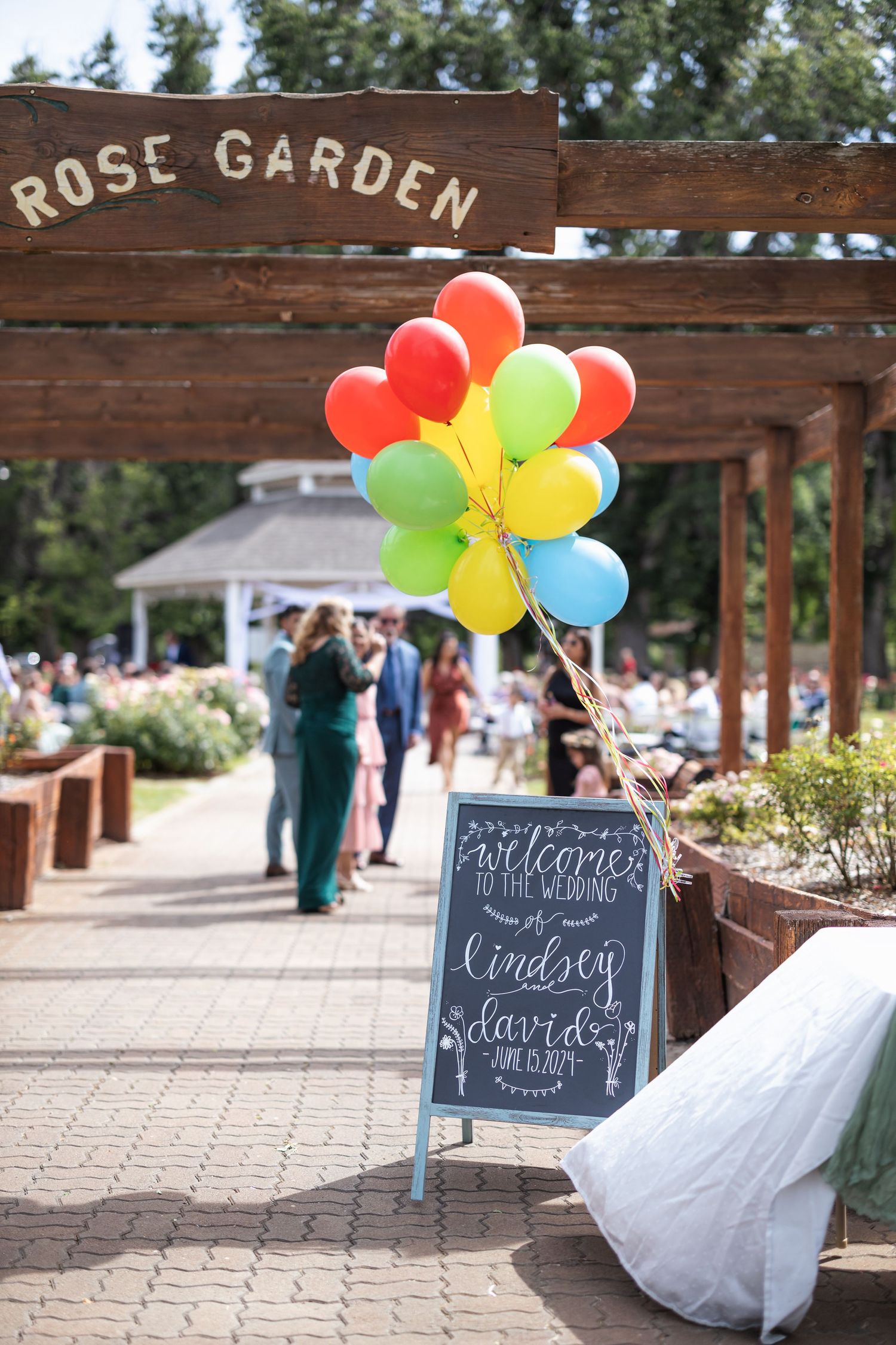 Rose Garden entrance decorated with colorful balloons and welcome sign for wedding celebration.