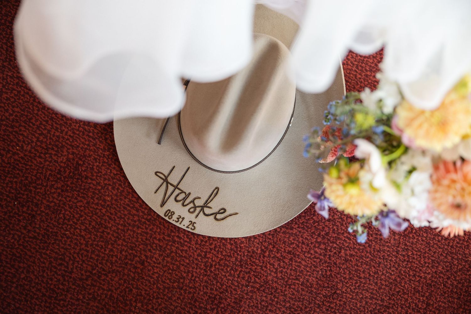 Wedding reception place settings with elegant white plates and gold flatware.