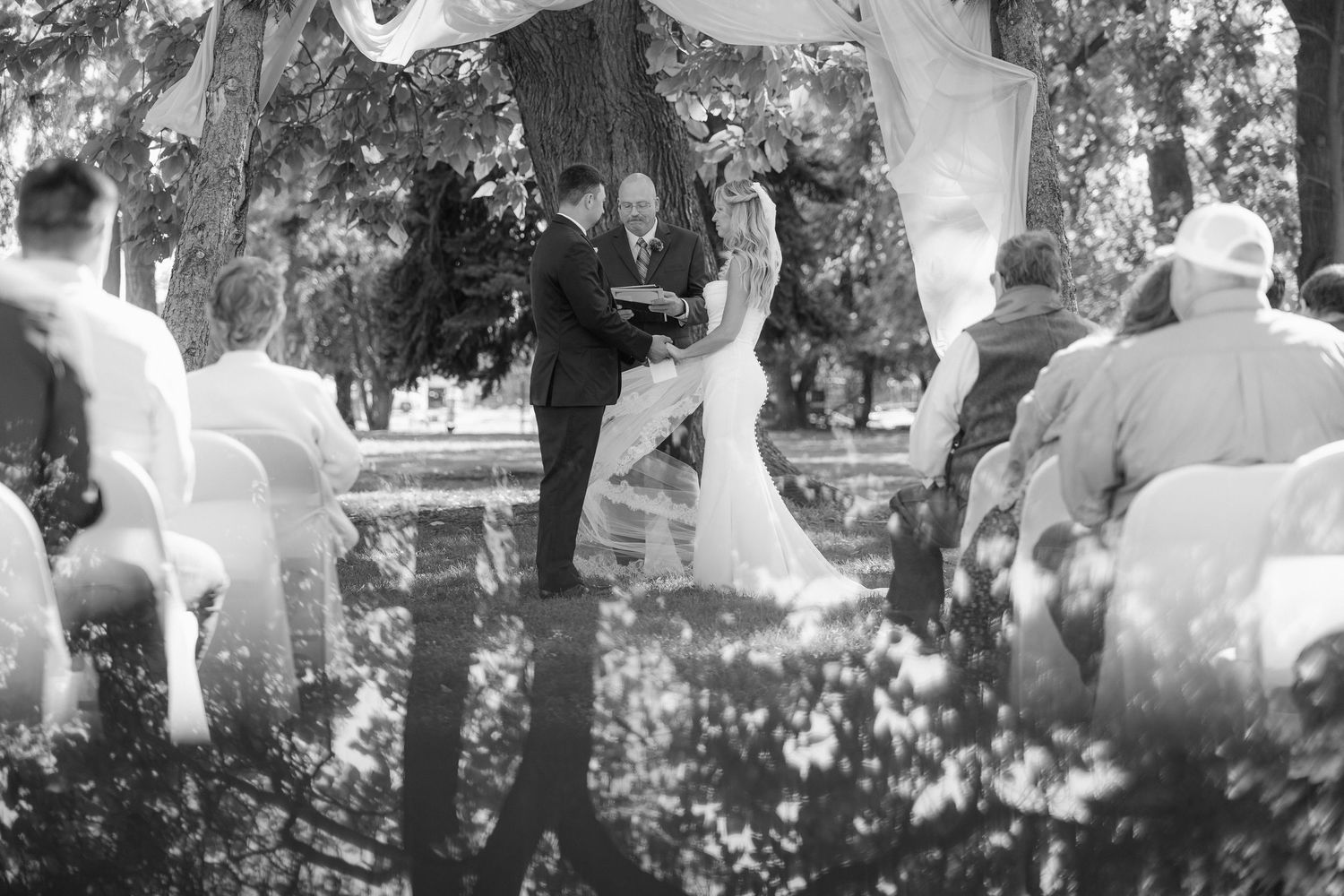 Black and white photo series capturing romantic dance movements in a garden setting.