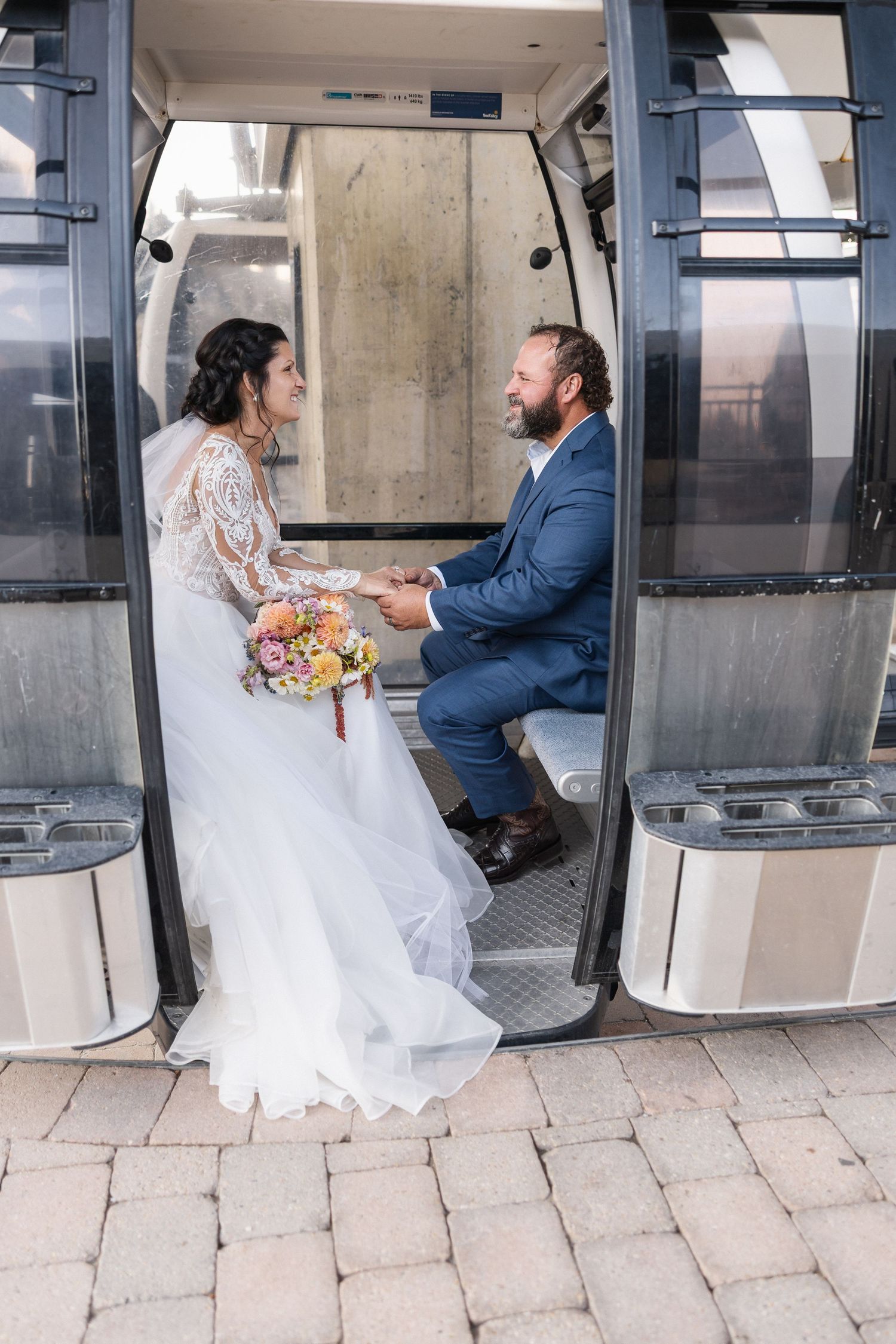 Series of photos showing newlyweds riding in a ski gondola with white dress flowing.