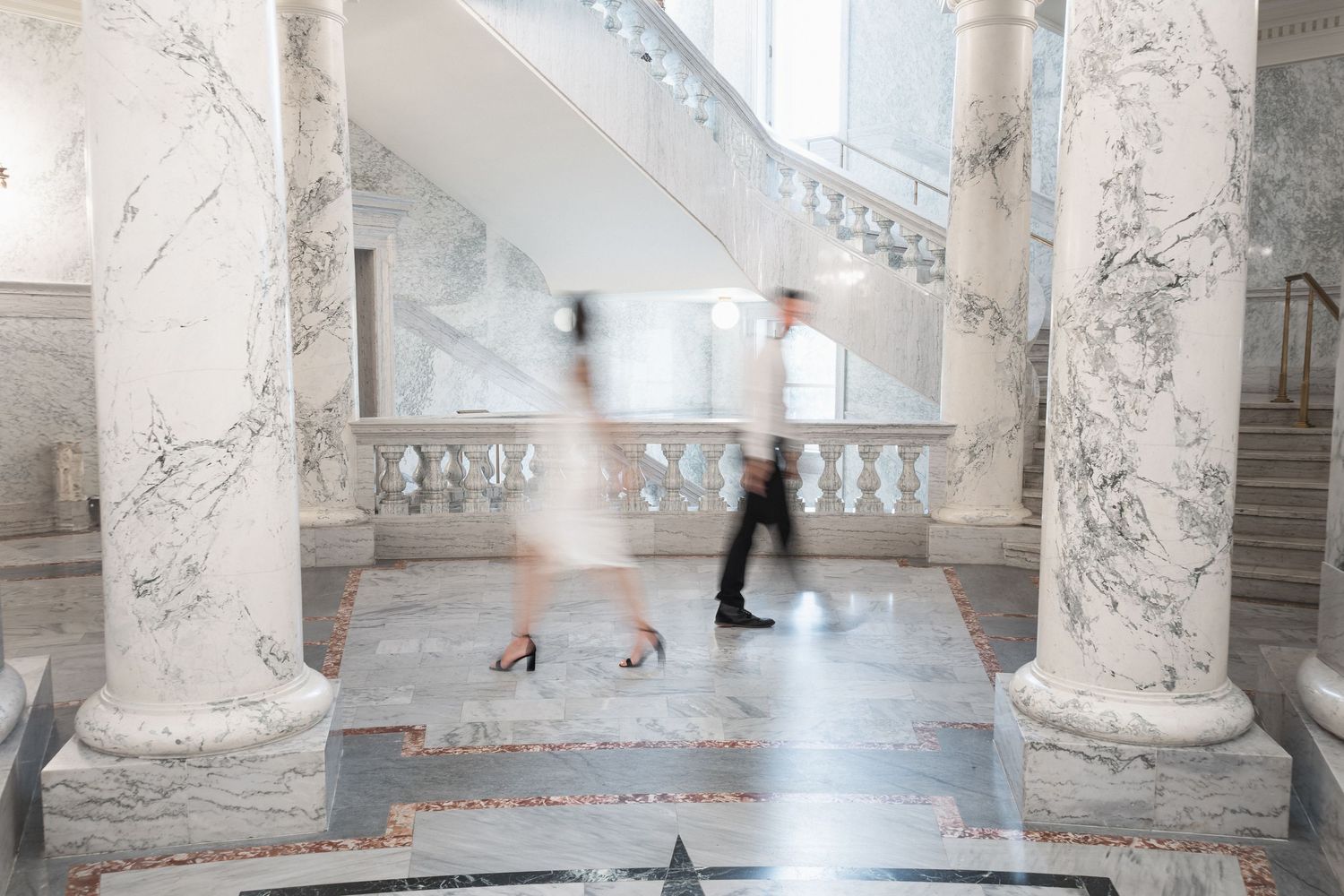 Interior architecture featuring marble columns and elegant floor patterns.