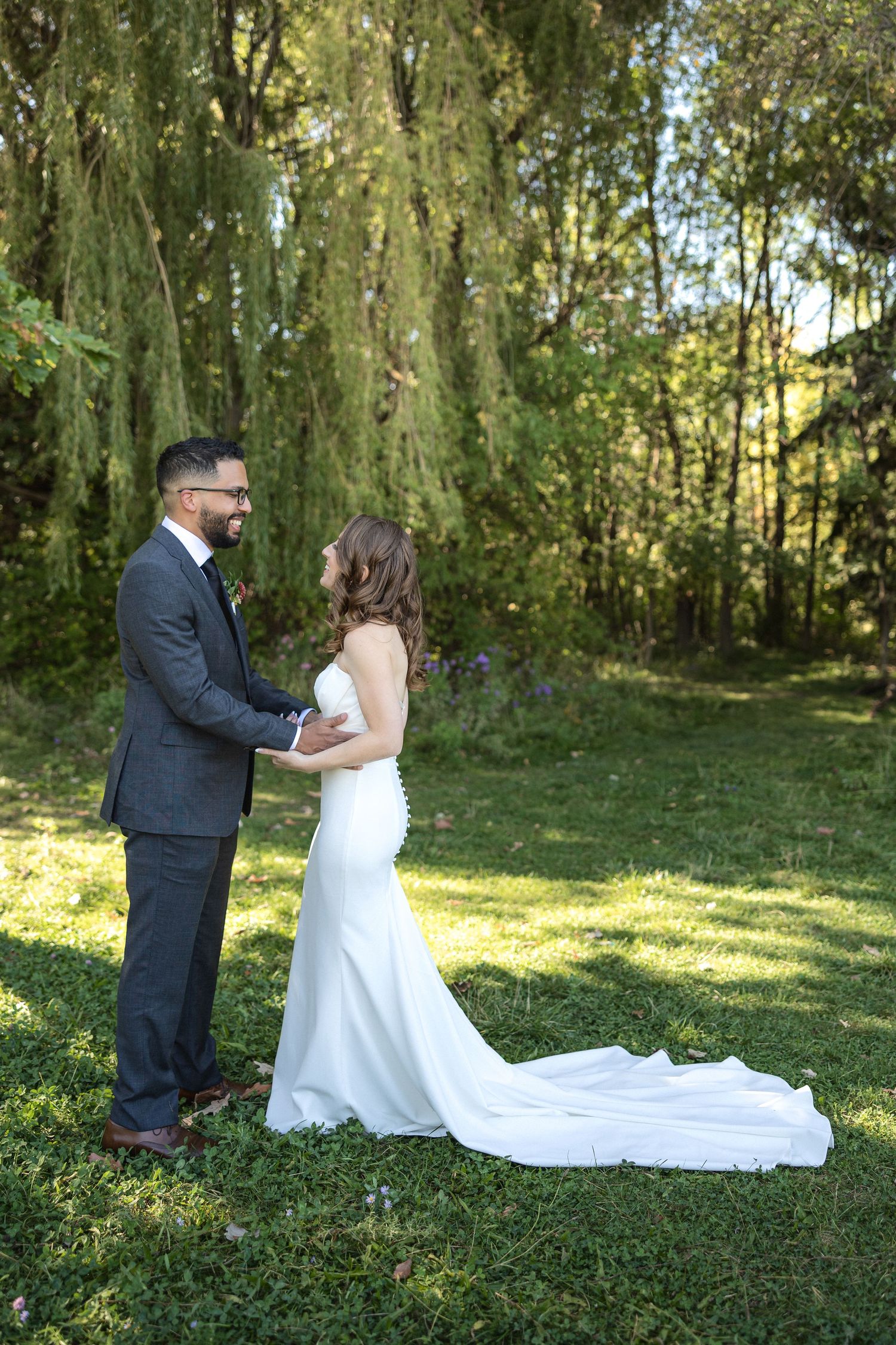 A romantic wedding moment captured in a sunlit garden setting.