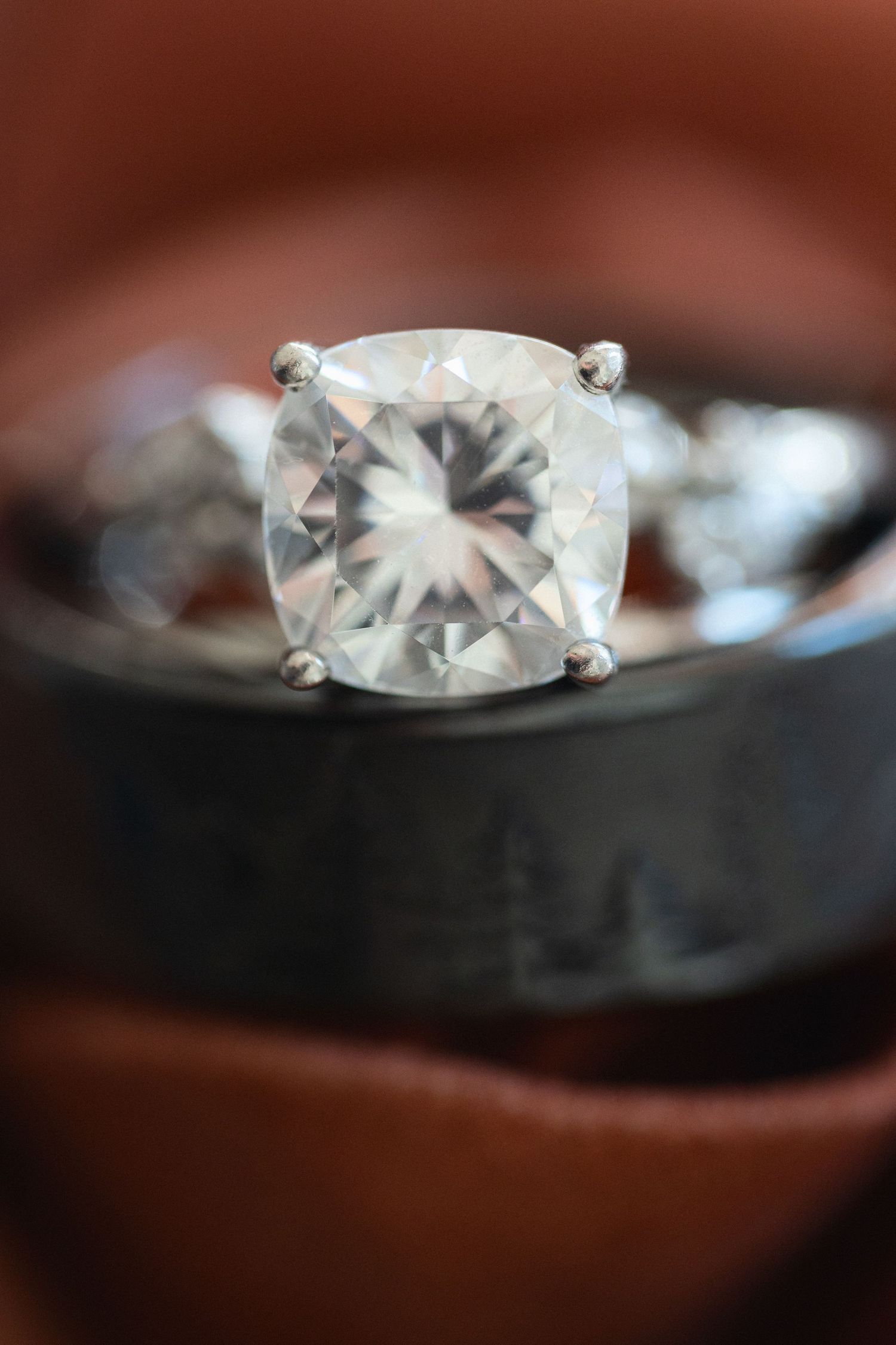 Close-up of a cushion-cut diamond engagement ring with prong setting.
