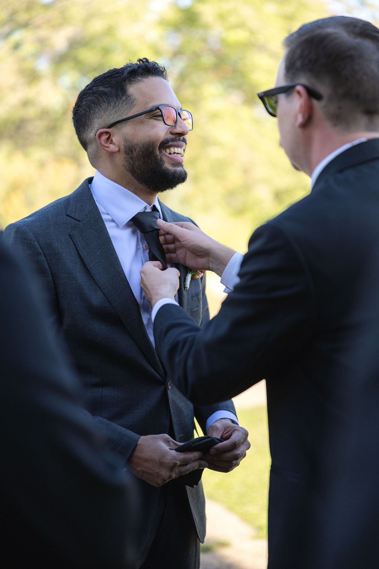 A tender moment between two people in formal attire during a wedding ceremony.