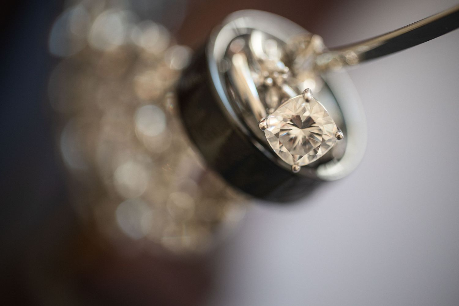 Macro shot of a diamond ring setting with sparkles and bokeh effect.