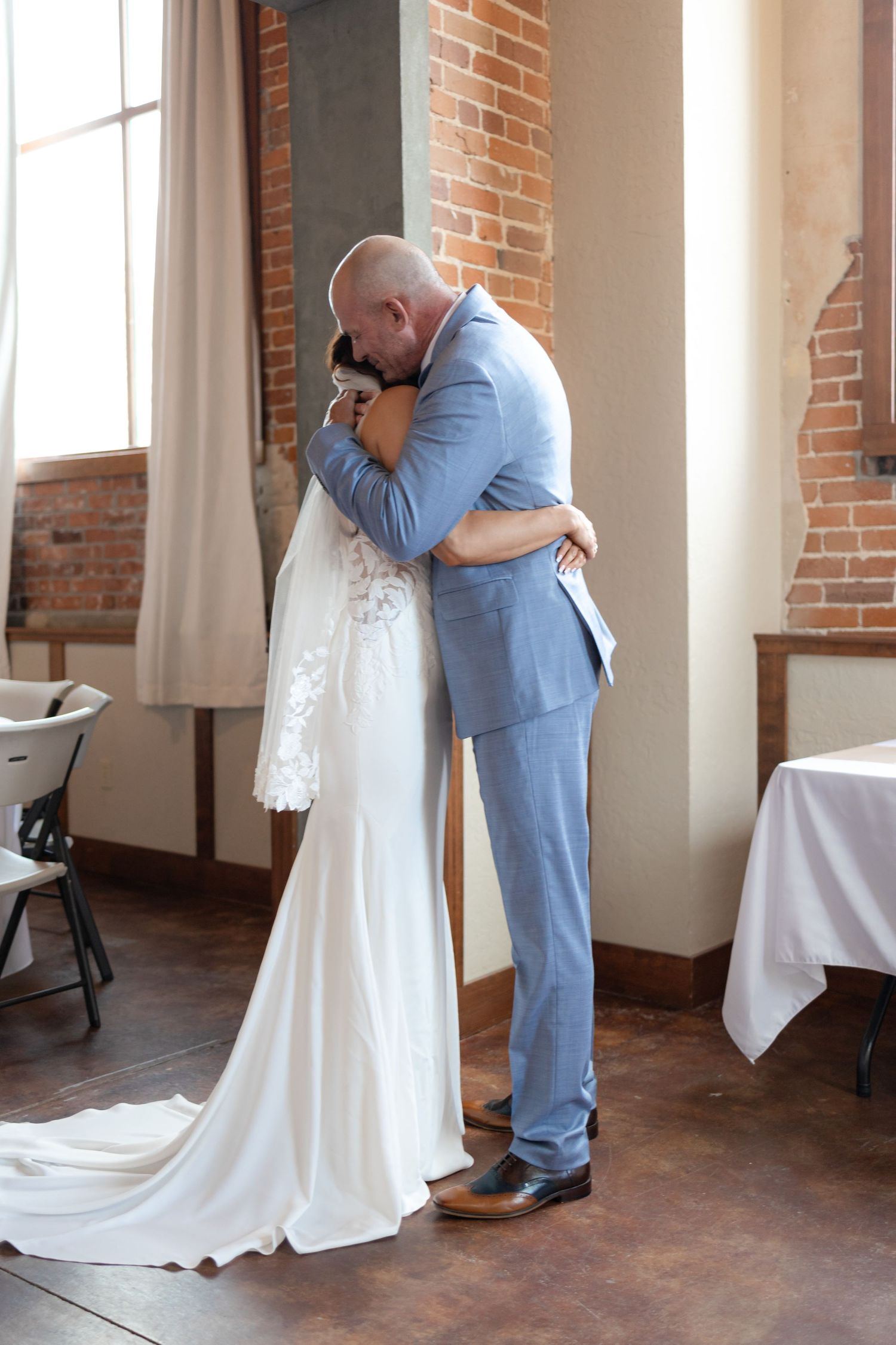 Emotional wedding moment captured between couple in intimate embrace.