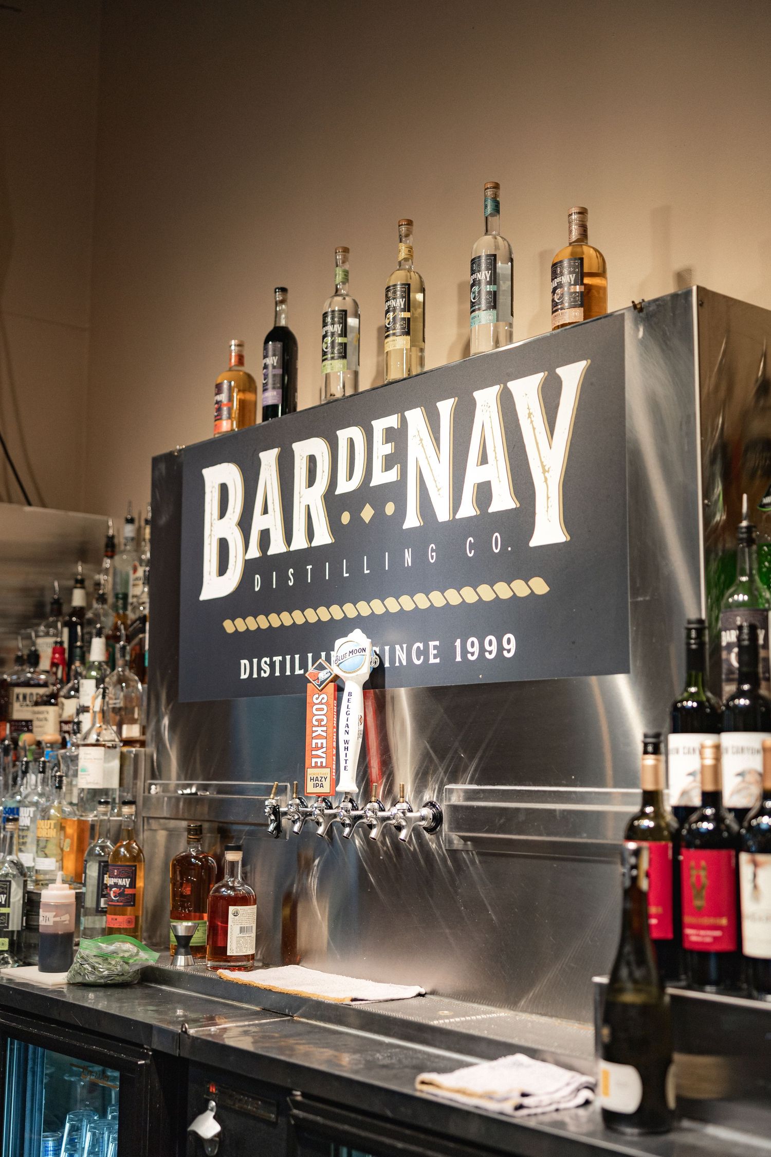 Bar setup with Bardenay Distilling Co. signage and liquor bottles on display.