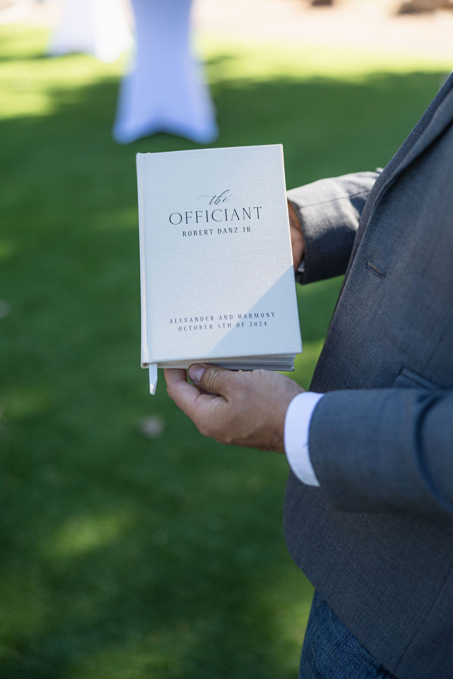 Wedding officiant cards and documentation shown in natural outdoor lighting.