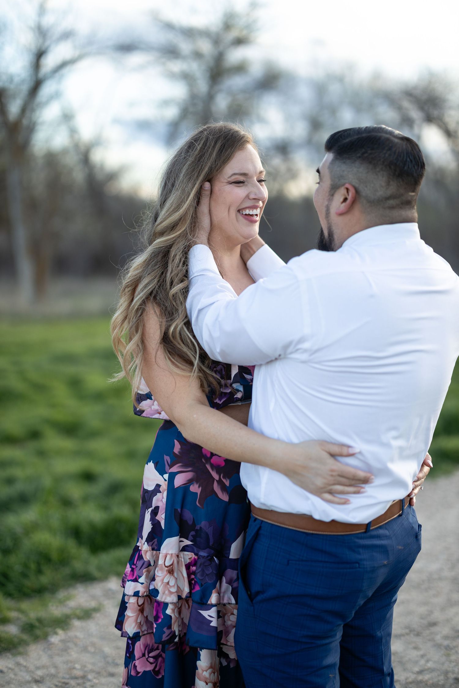 Joyful embrace captured during an outdoor photoshoot on a nature path.