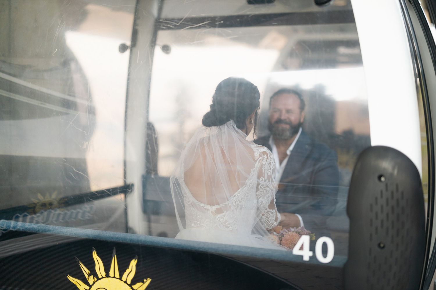 Scenic mountain gondola ride capturing special wedding moments through the window.