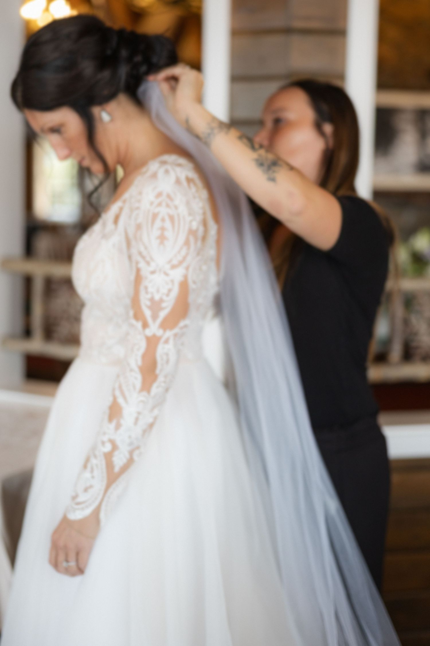 Close-up details of lace sleeves on a white wedding dress.