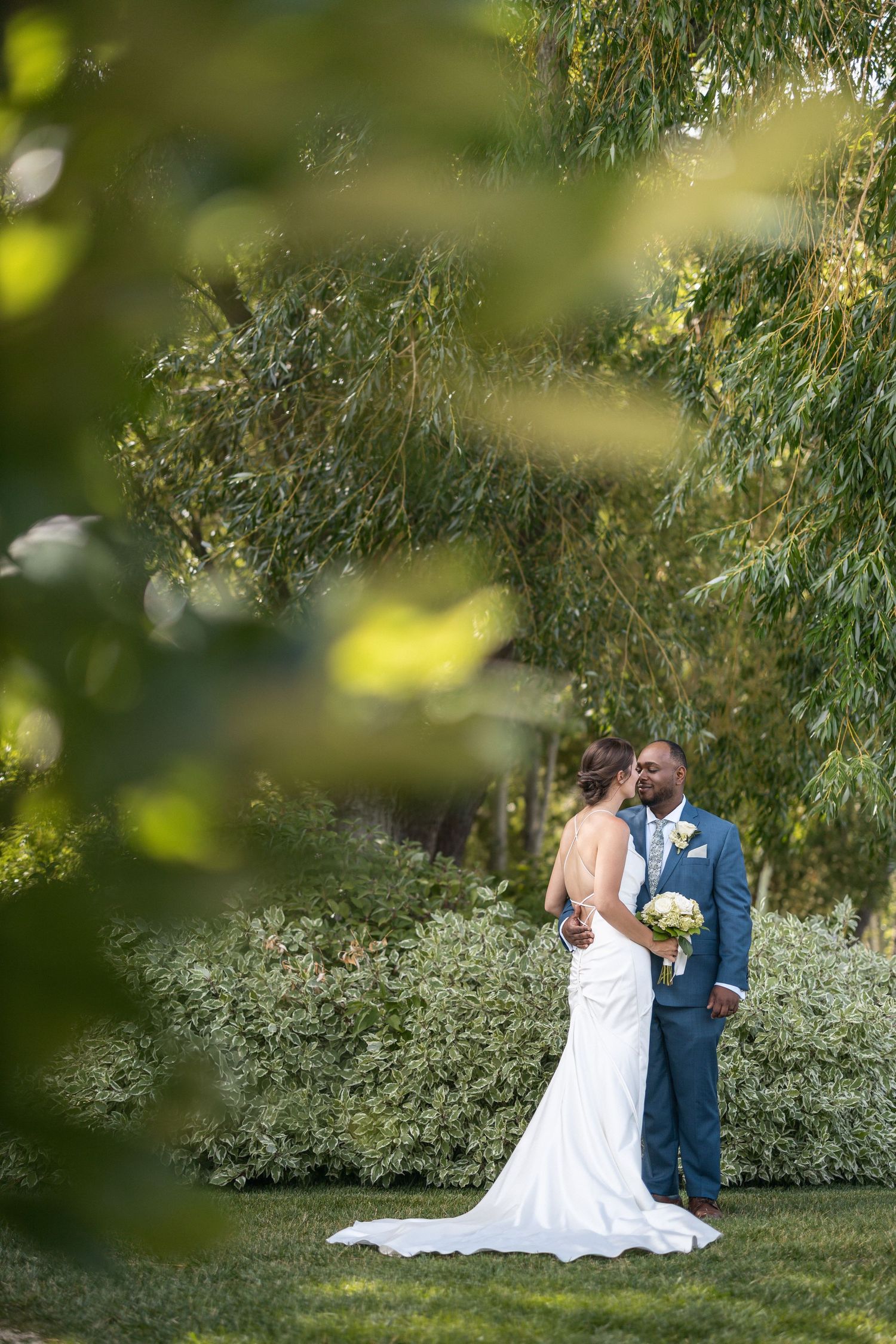 A romantic garden wedding scene with soft natural lighting filtering through trees.