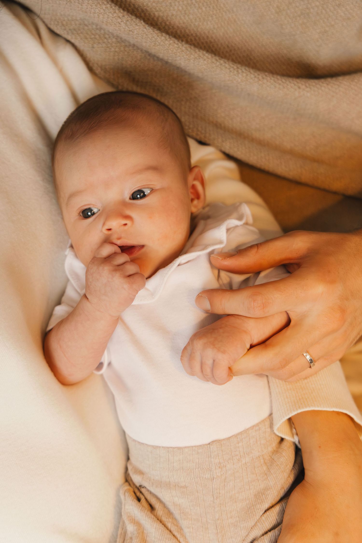 Close-up portrait of a newborn baby during a lifestyle newborn photoshoot.