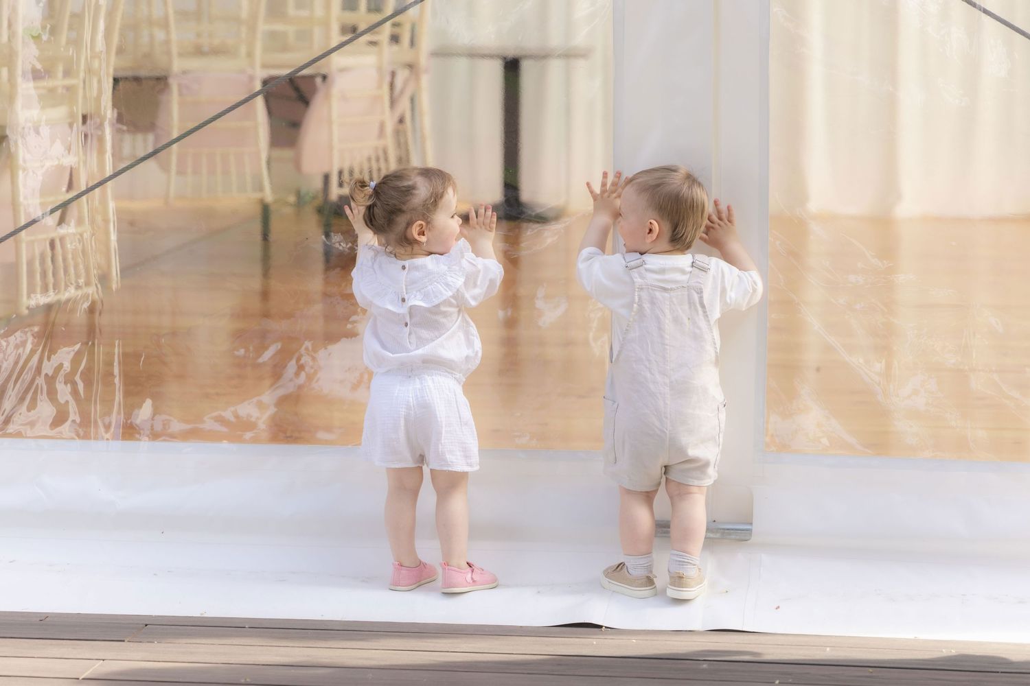 Photo of little girl and boy playing together during joyful birthday party.