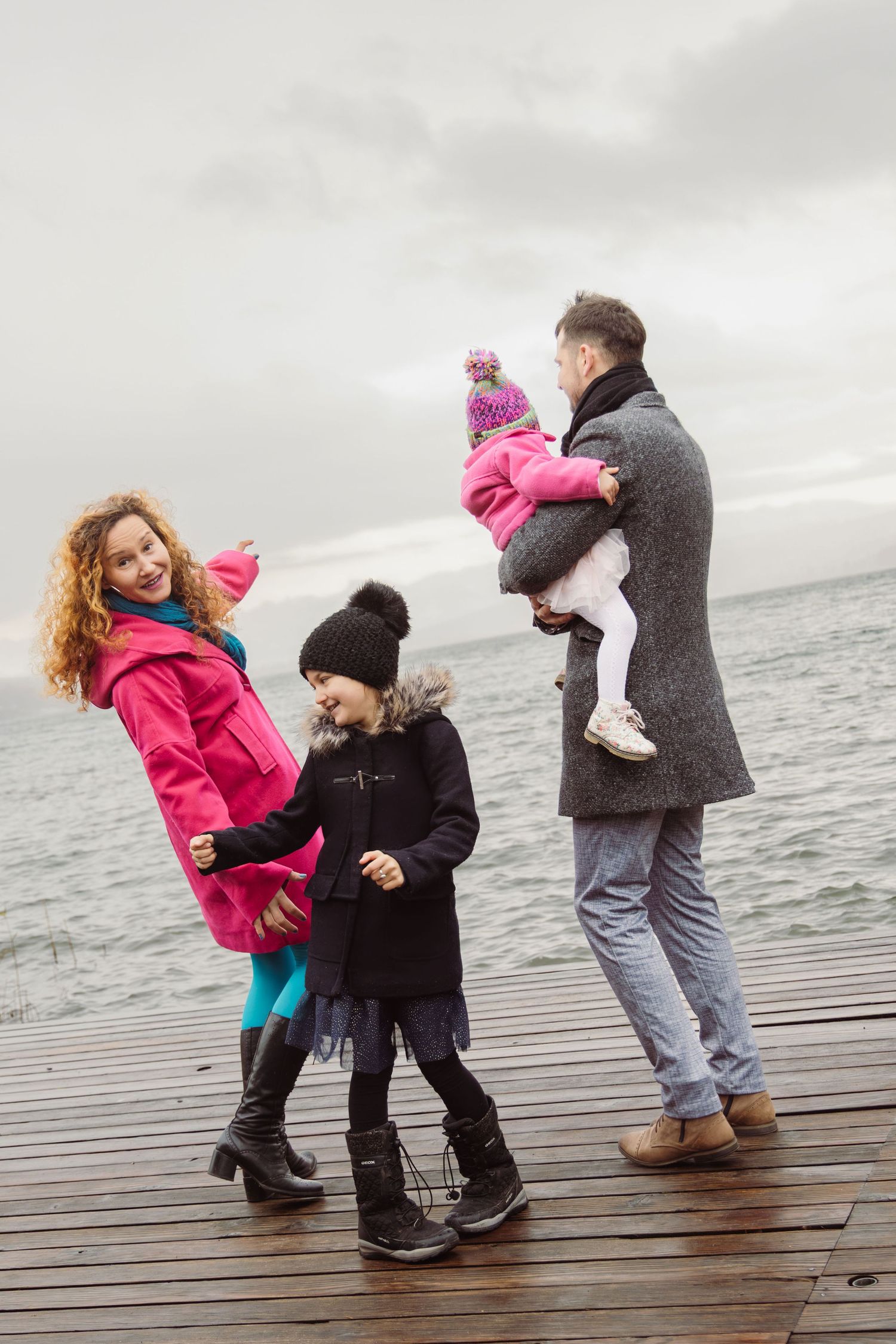 Family dancing together during a joyful lifestyle family photoshoot outdoors,