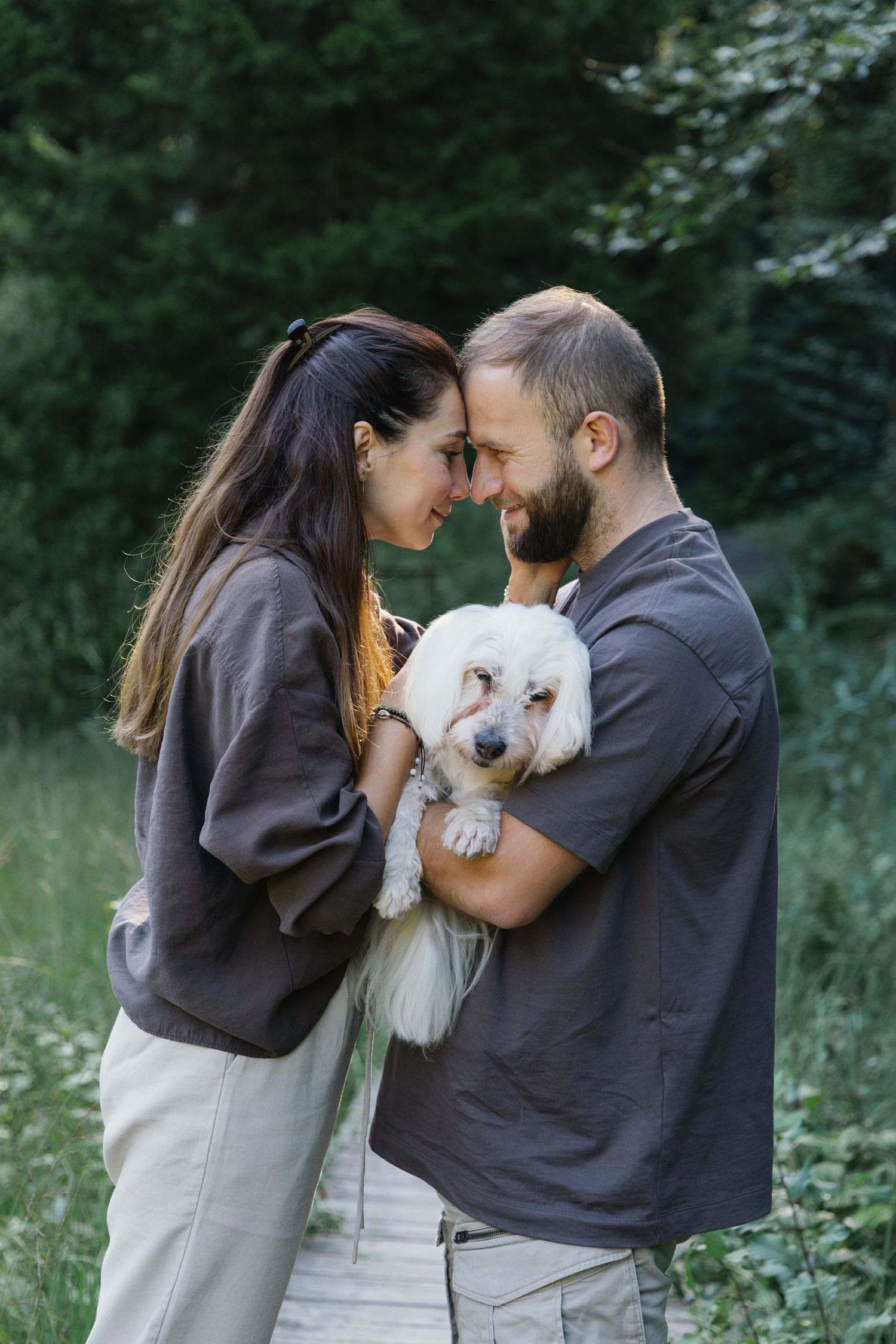 Couple spending time with their dog during an outdoor lifestyle photoshoot in Switzerland.