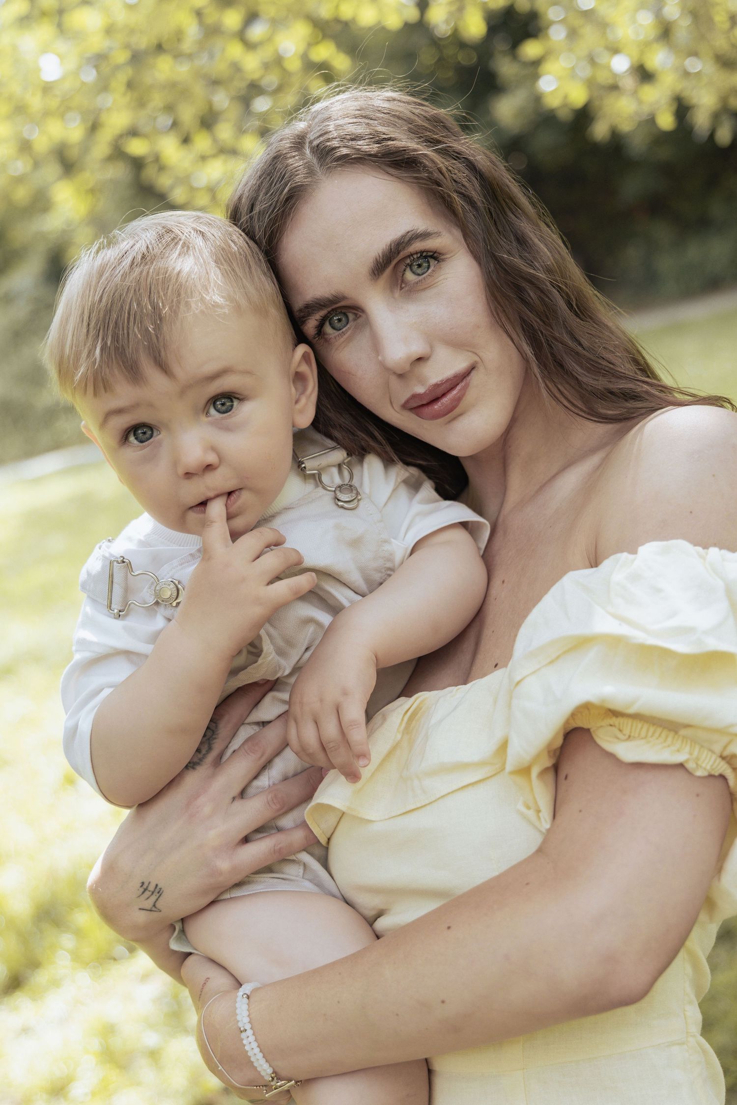 Mother and son spending time together in a park during a natural family photoshoot.