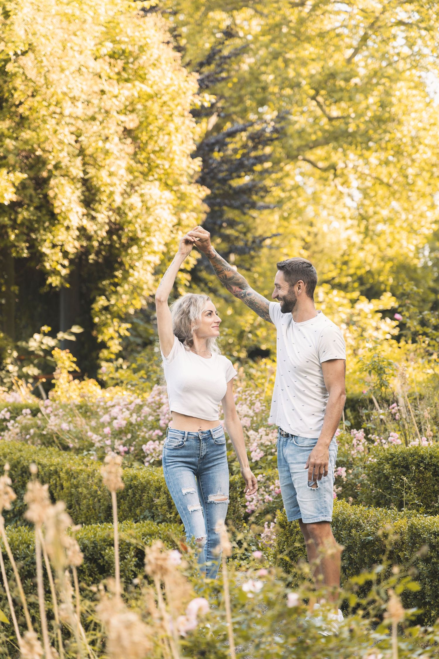 Couple dancing together during a joyful outdoor couples photoshoot.
