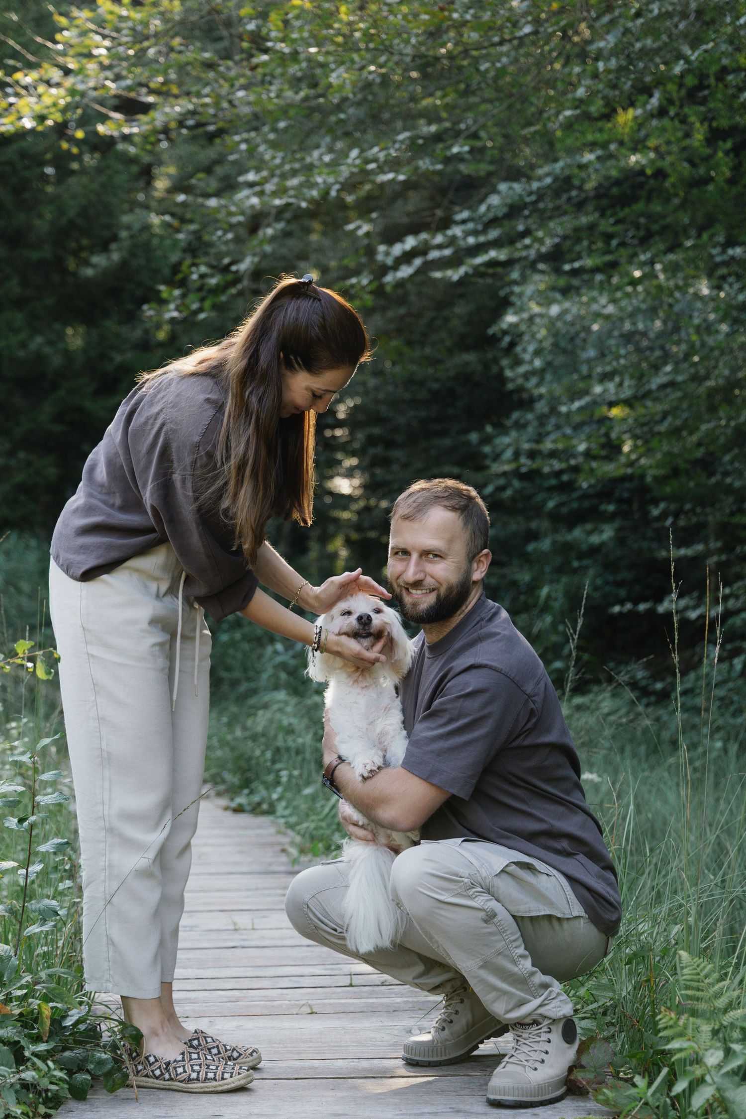 Couple spending time with their dog during an outdoor lifestyle photoshoot in Switzerland.