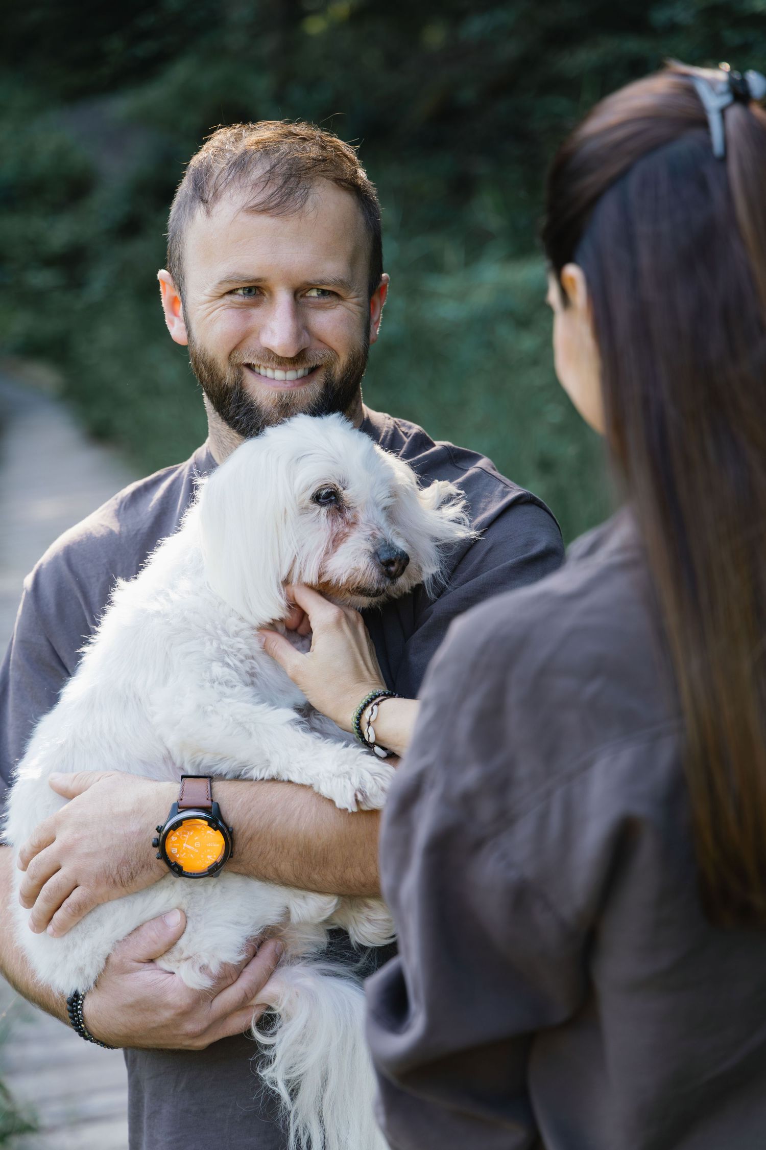 Close-up portrait of a couple with their senior dog during a lifestyle family photoshoot.