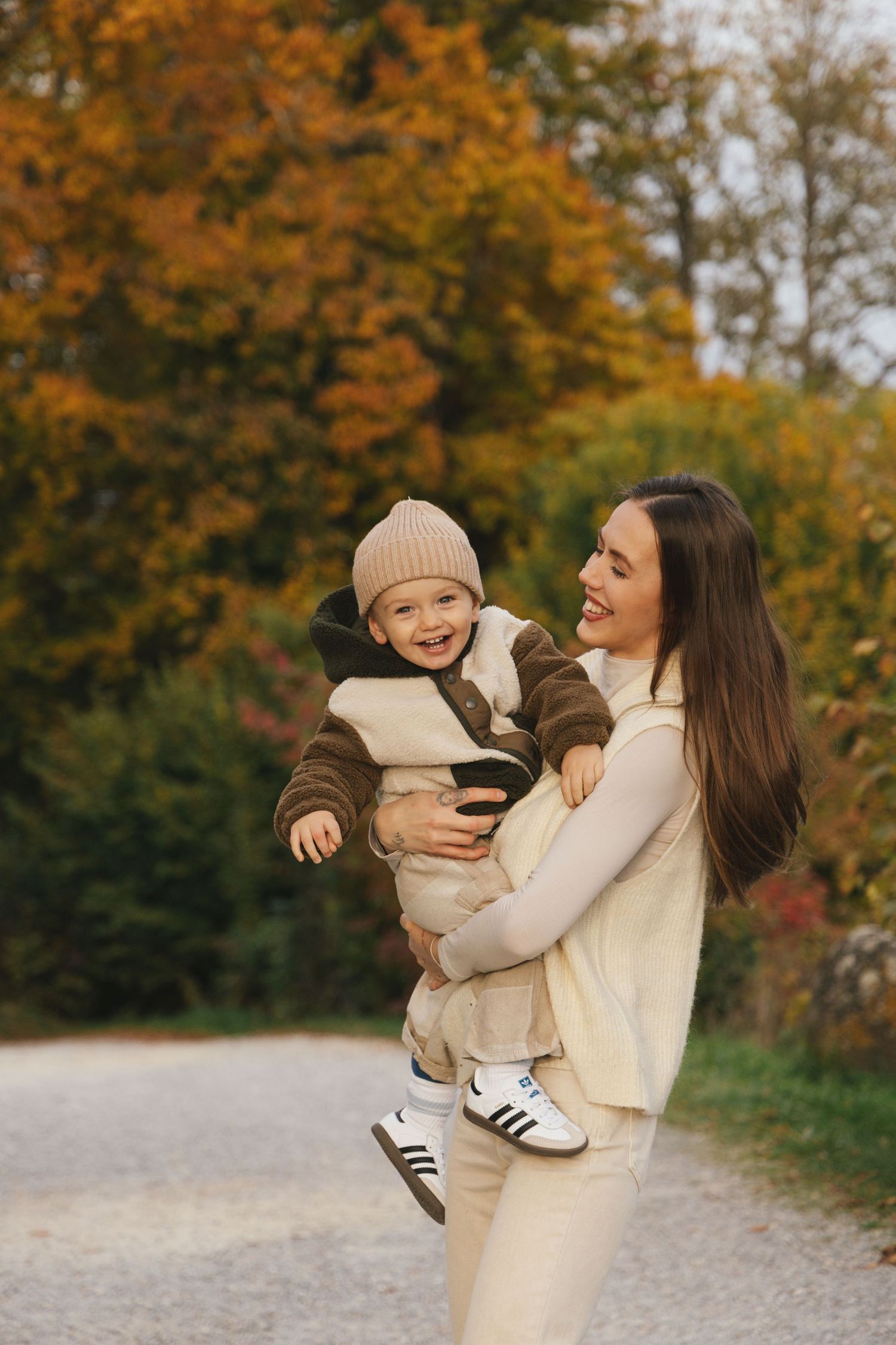 Mother and son laughing together during autumn family photoshoot in Switzerland.
