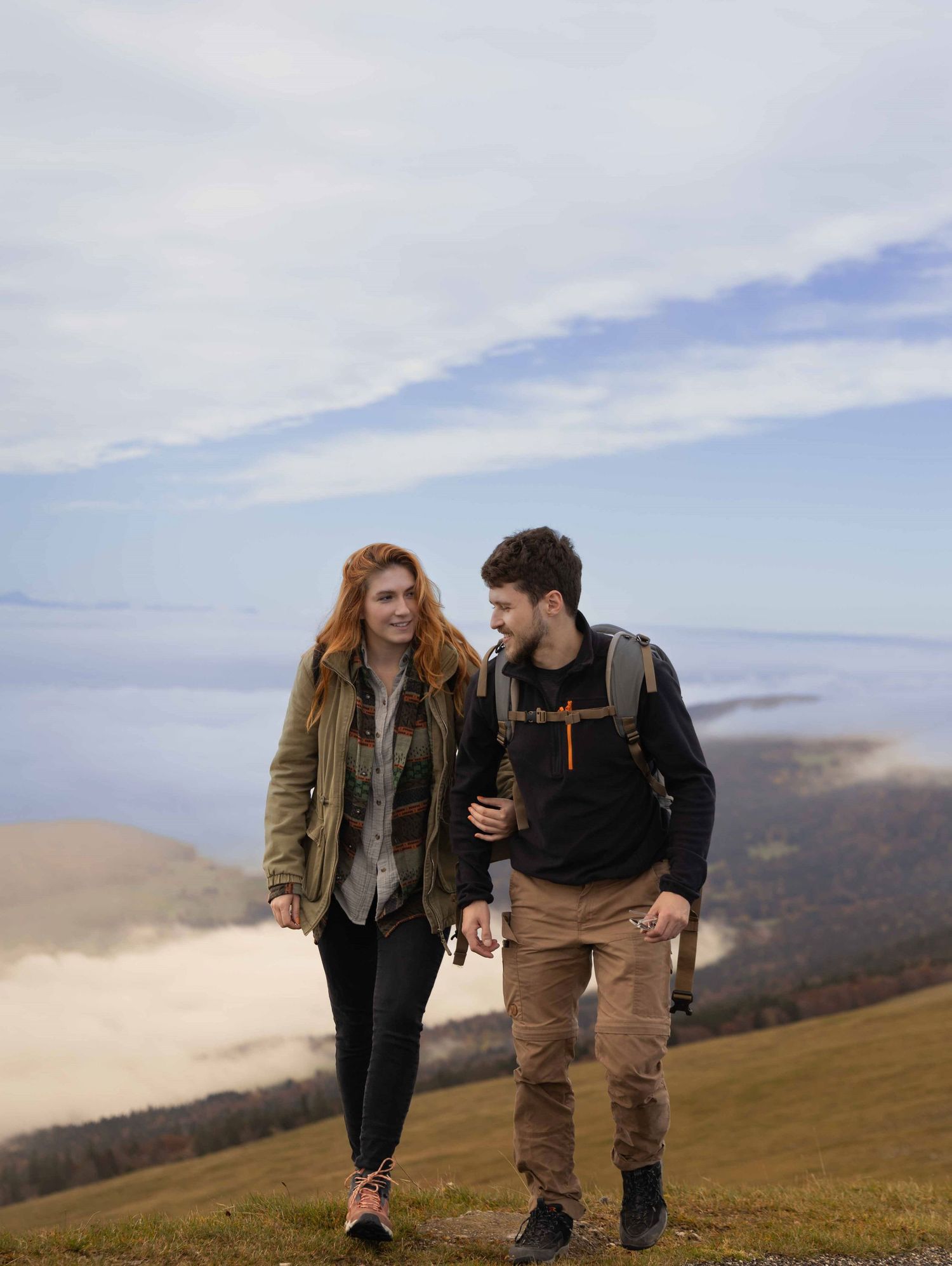 Couple walking together during a hiking couples photoshoot in Switzerland.