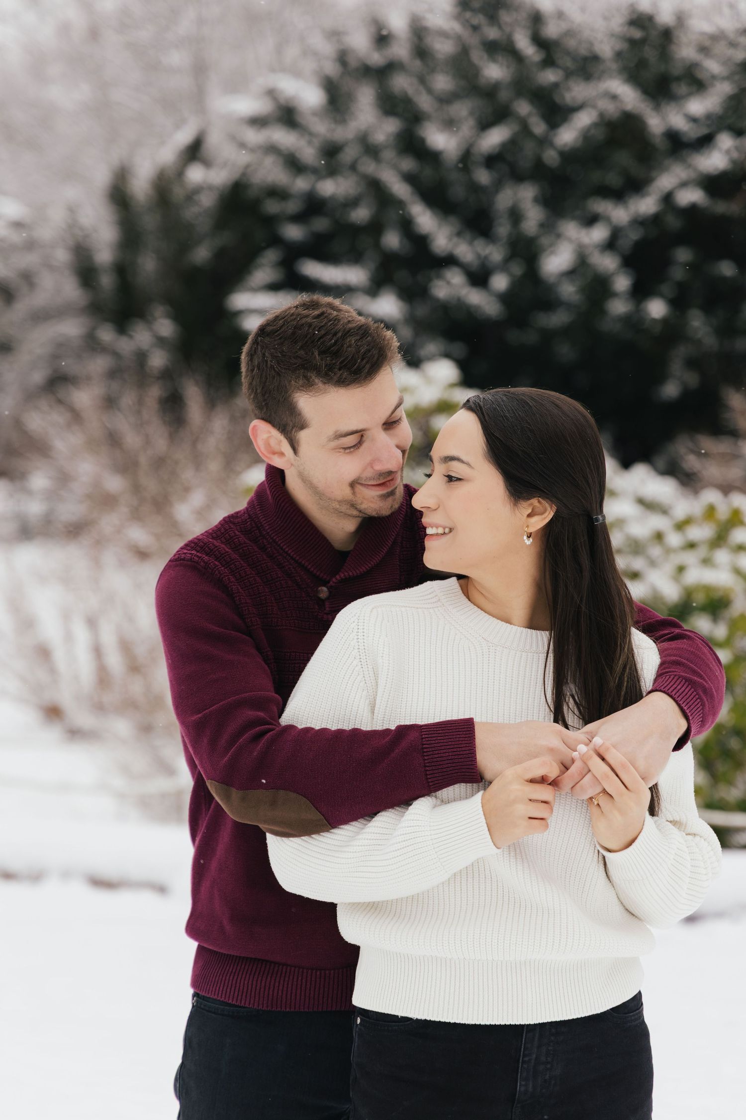 Romantic couple in the snow during a winter couples photoshoot in Switzerland.