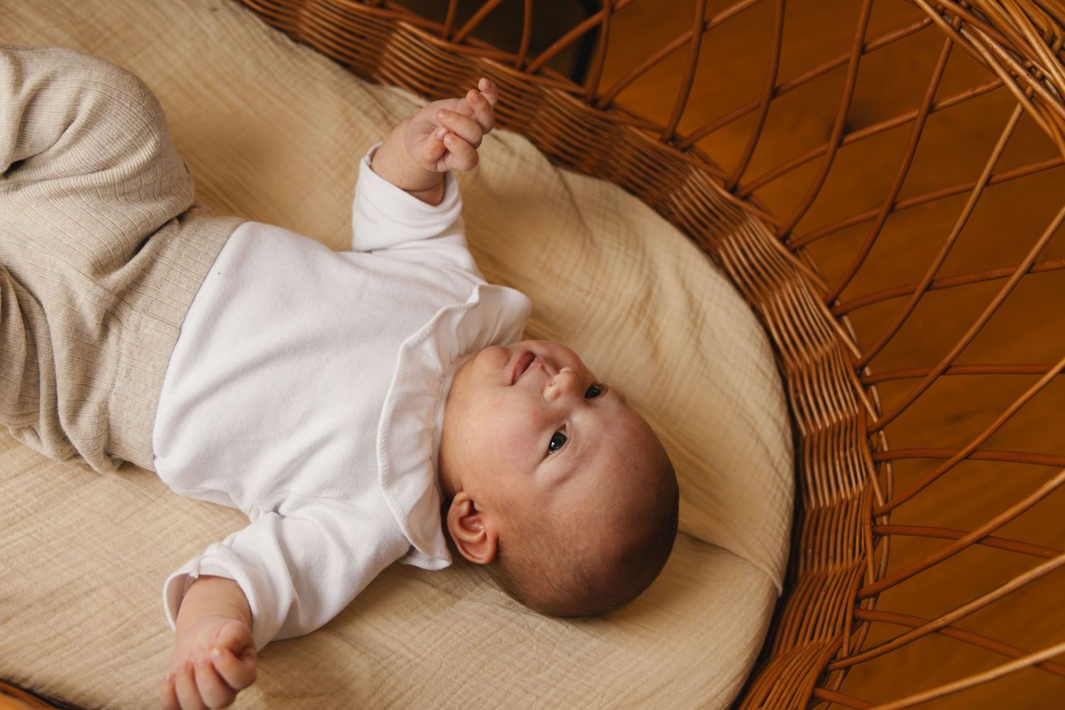 Newborn baby laying in a crib during a calm lifestyle newborn photoshoot.